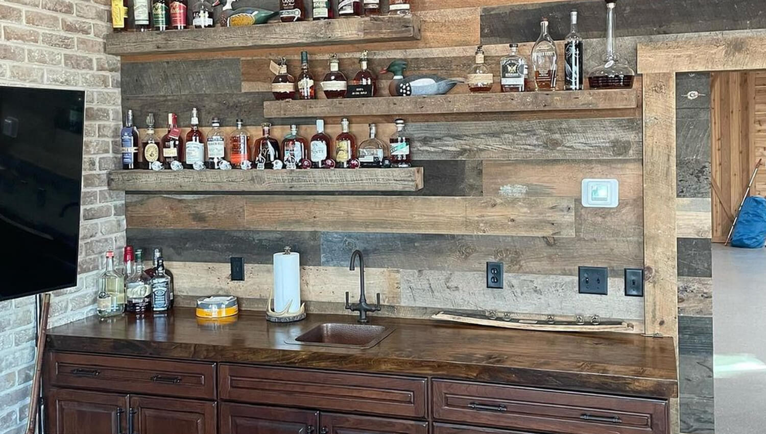 This Whiskey room design by Mevers Kitchen & Bath features a rustic wet bar with Dura Supreme Cabinetry.