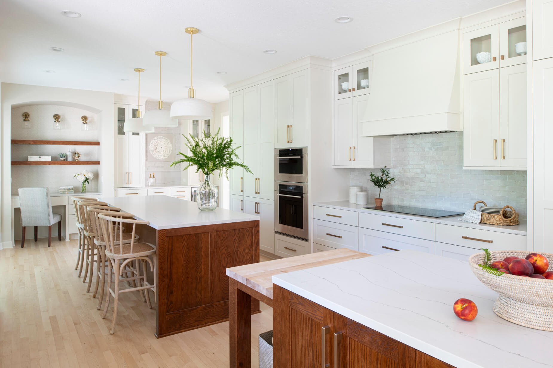 A long kitchen with two kitchen islands in a row.