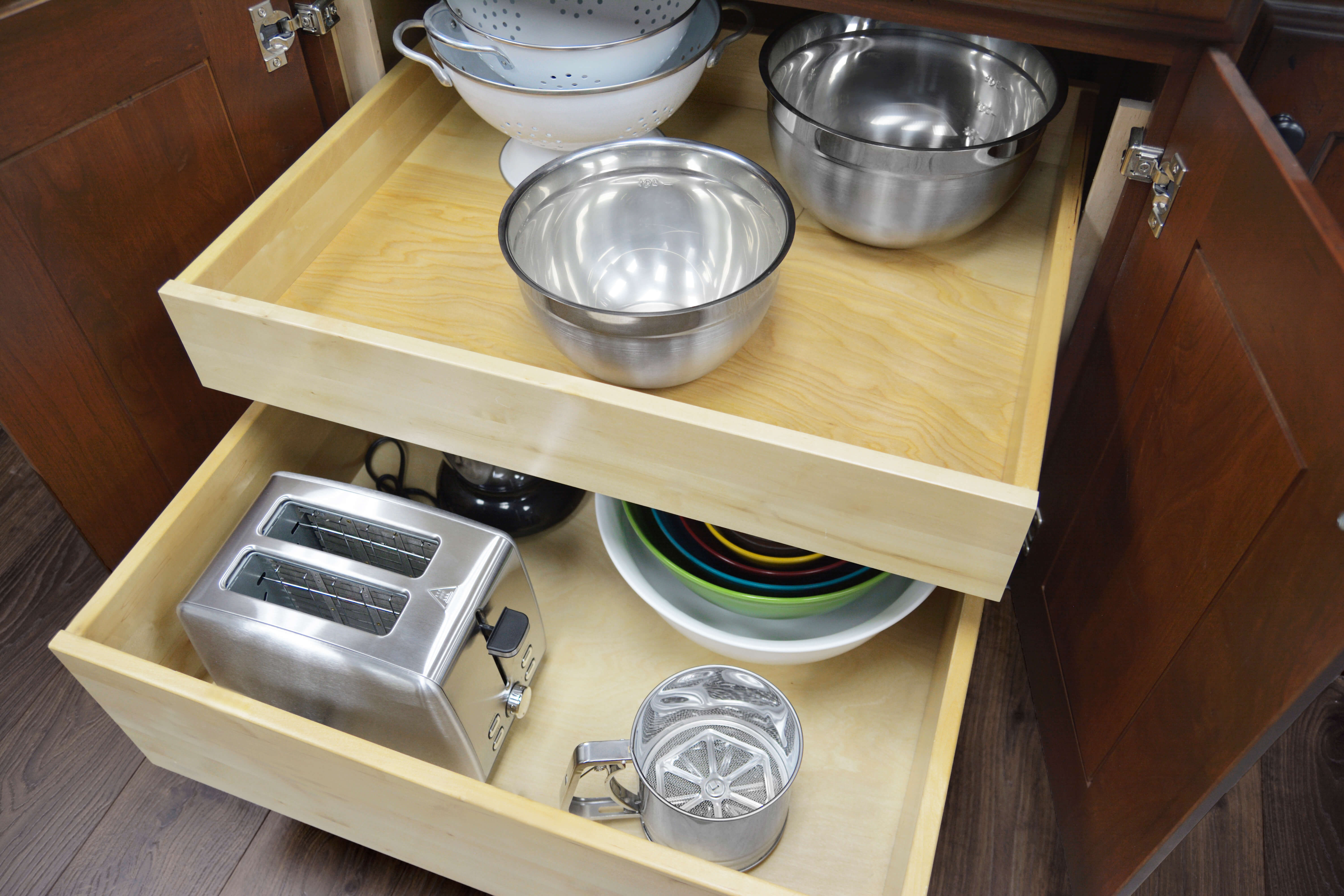A base kitchen cabinet with two roll-out shelves.