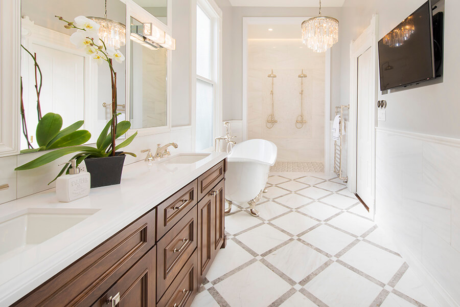 A traditional styled master bathroom with a wood stained vanity.