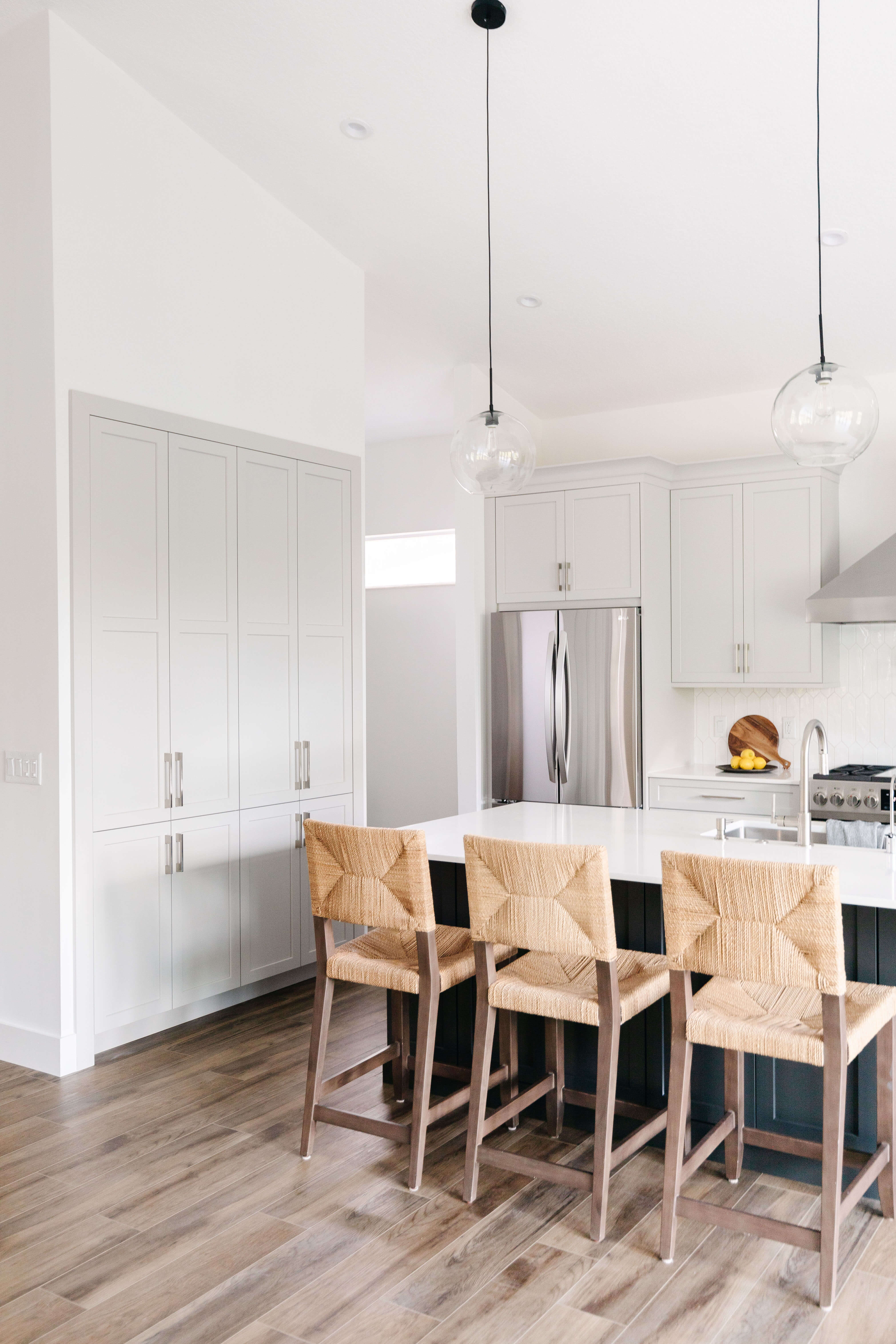 A kitchen remodel with tall vaulted ceilings and a wall of cabinet storage.