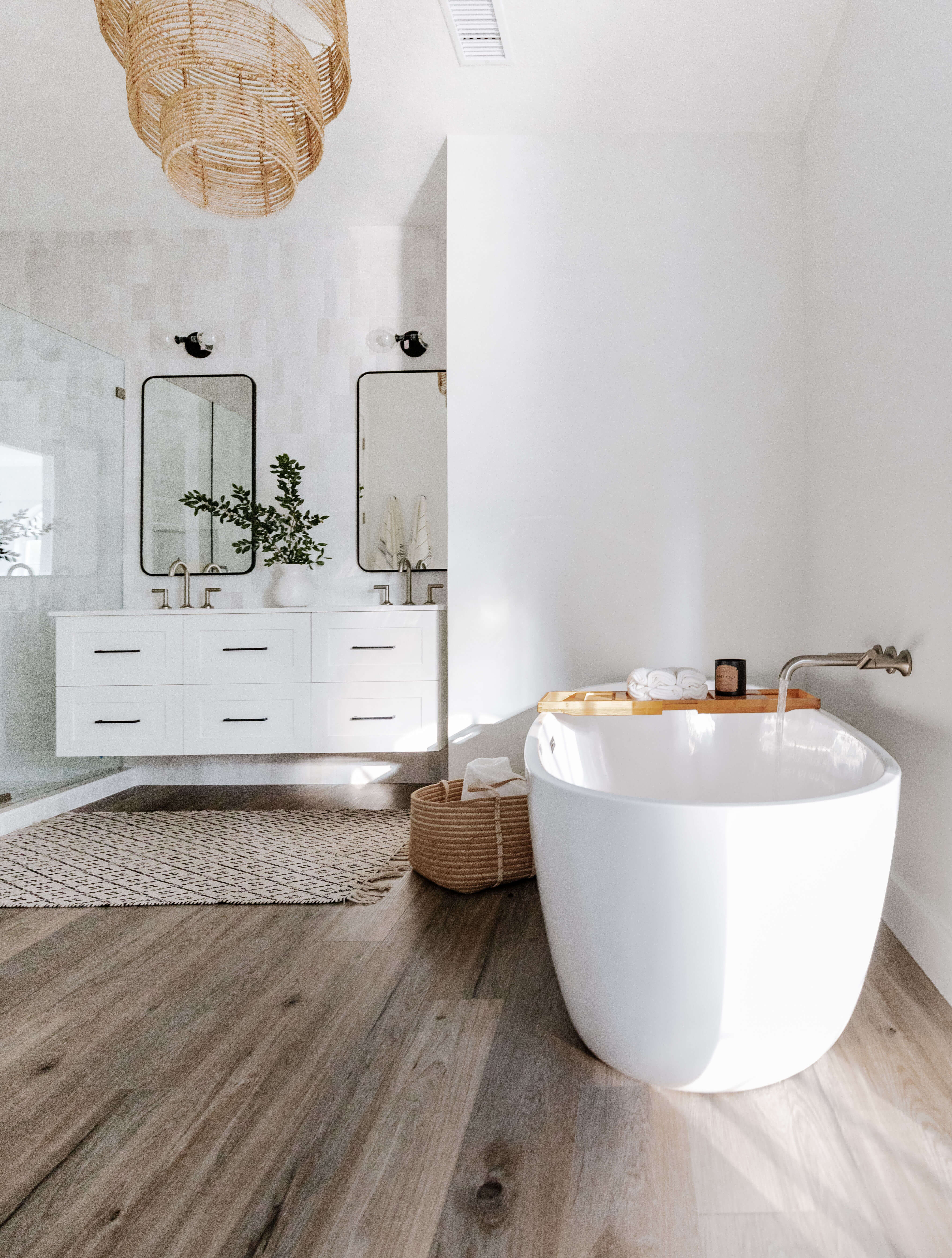 A Mid-Century Modern Master Bathroom Remodel with a White Floating Vanity and a freestanding tub.