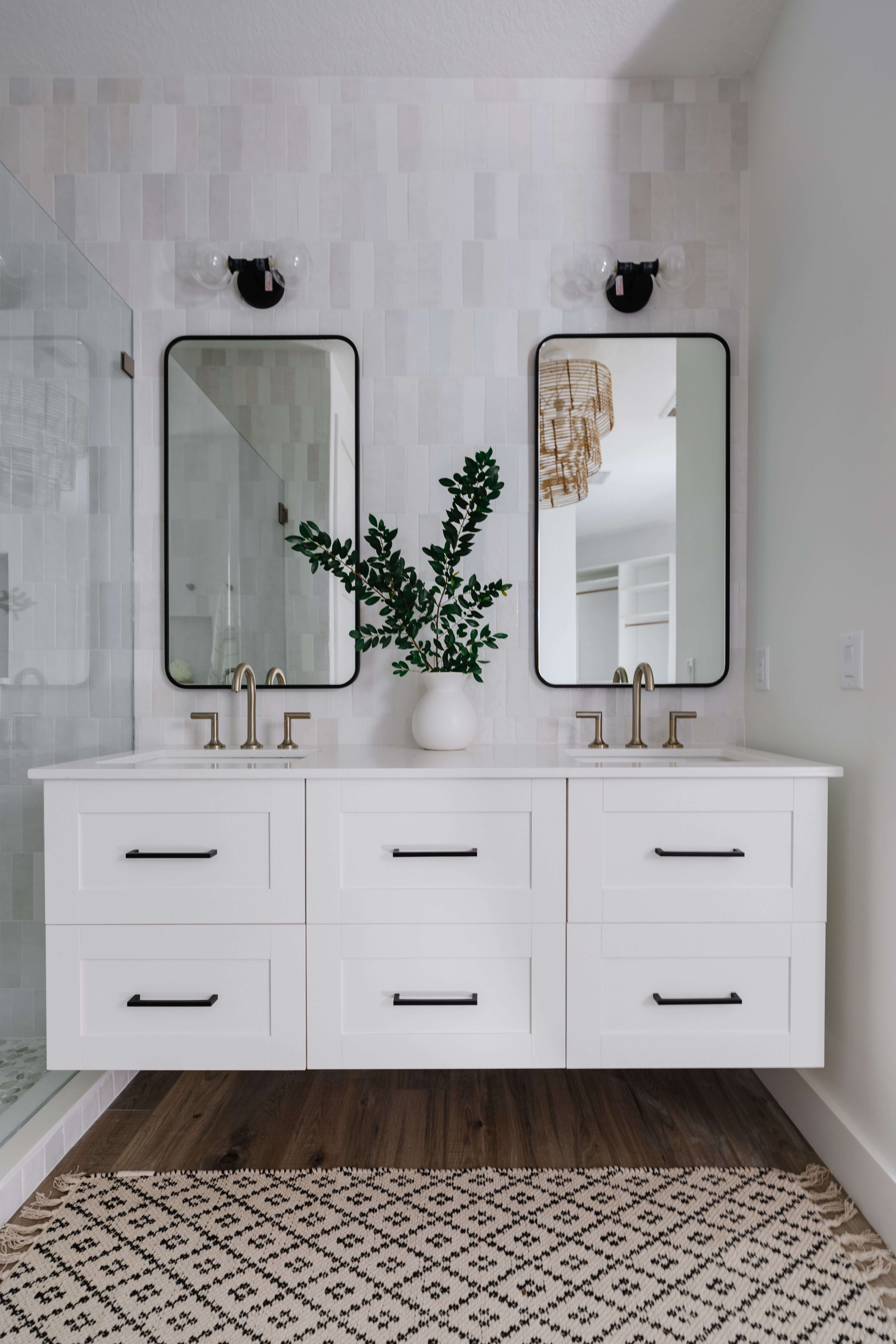 An elegant white painted floating vanity in a Mid-Century Modern Master Bathroom remodel.