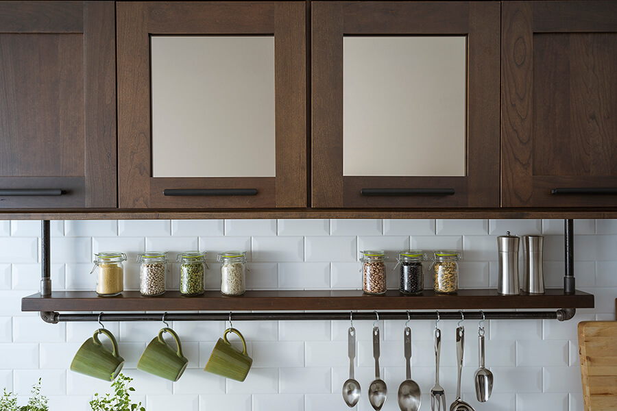 Bronze mirror insert in a glass cabinet door.