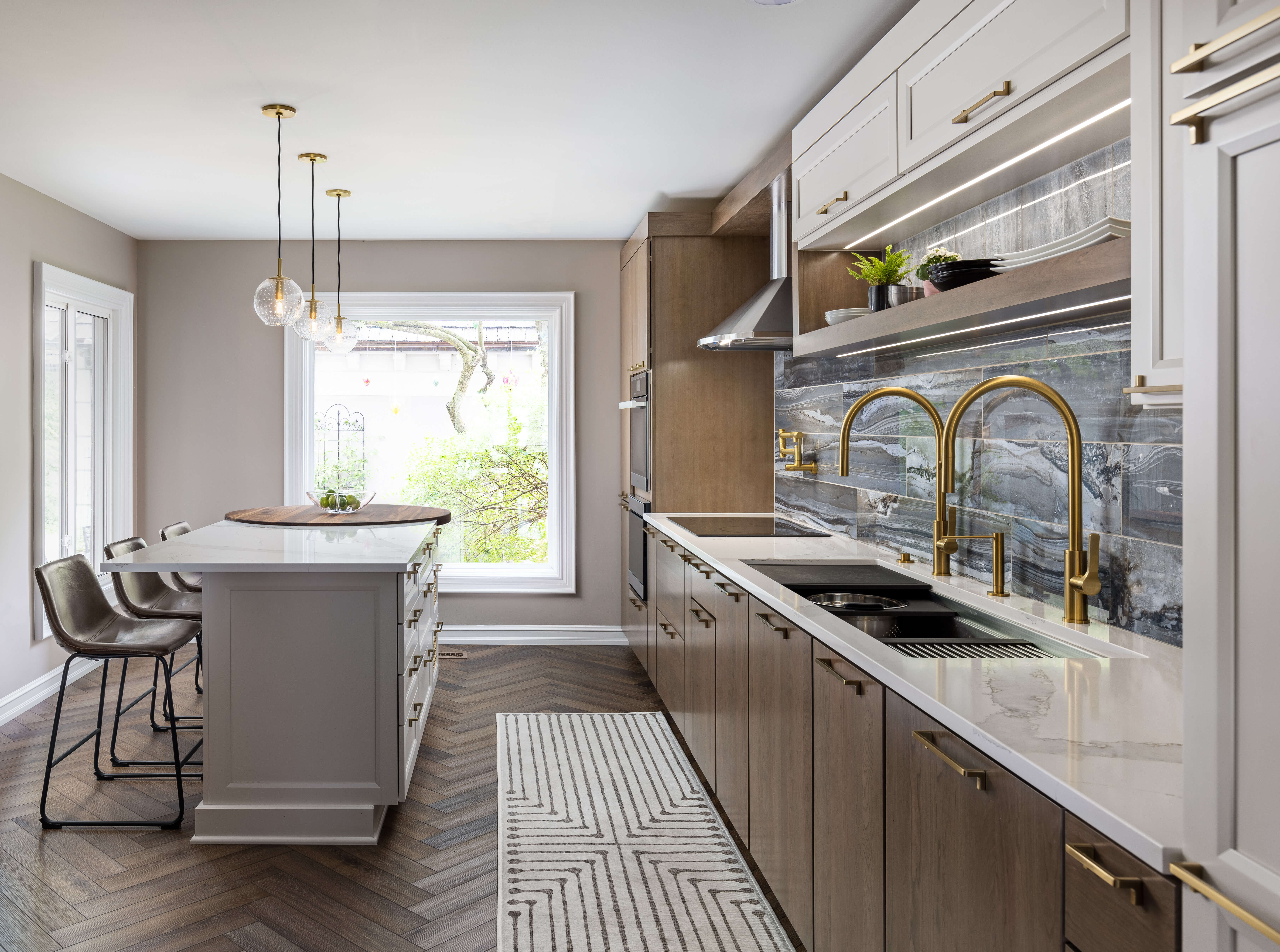 A stunning transitional style kitchen with two tones of cabinetry including a medium, true-brown stain oak, and tonal white painted kitchen cabinets.