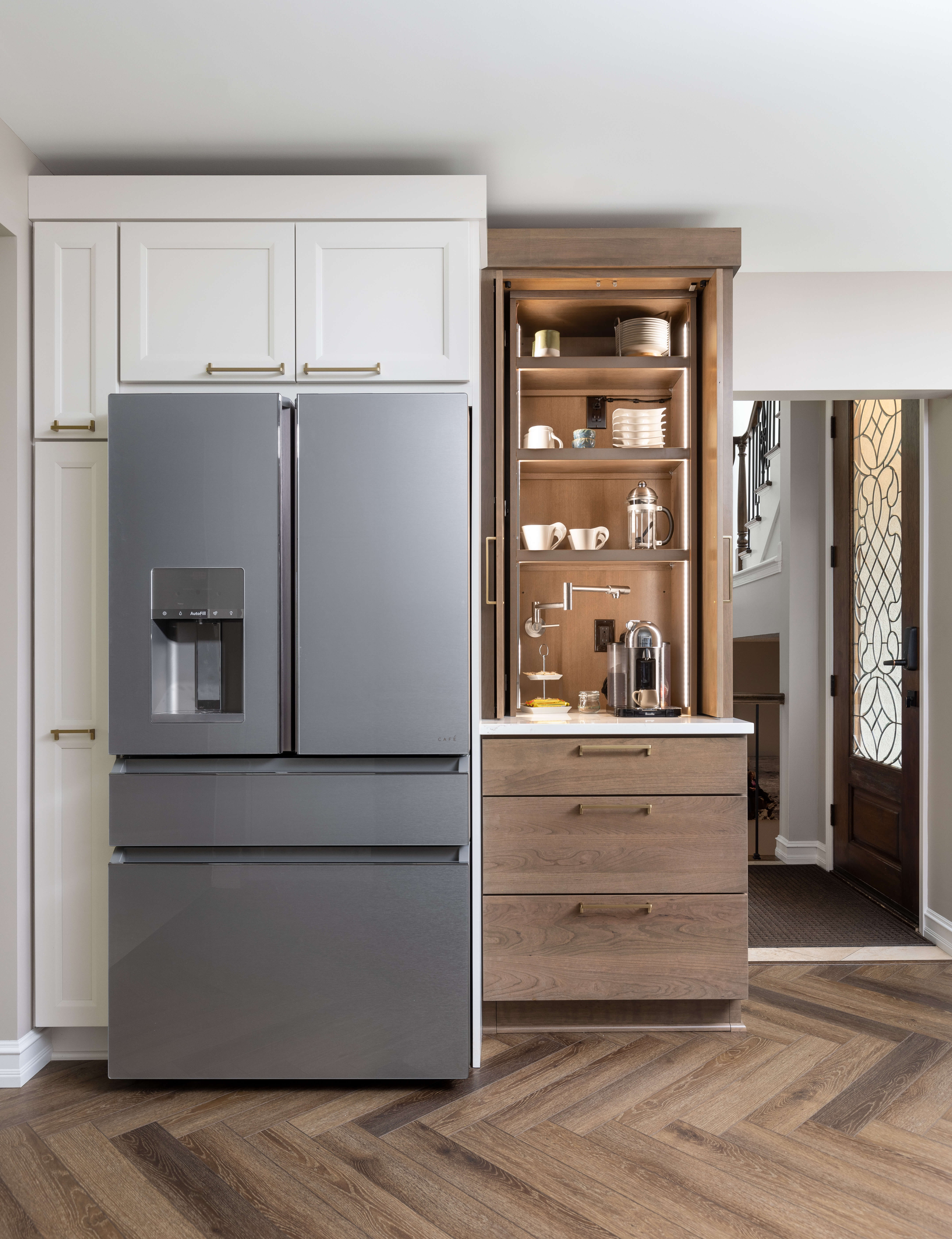 A working pantry and larder cabinet with a pot-filler for the coffee maker to create an easy-to-access coffee station that can be hidden away.