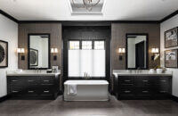 A Black & White master bathroom design with two modern black painted vanities.