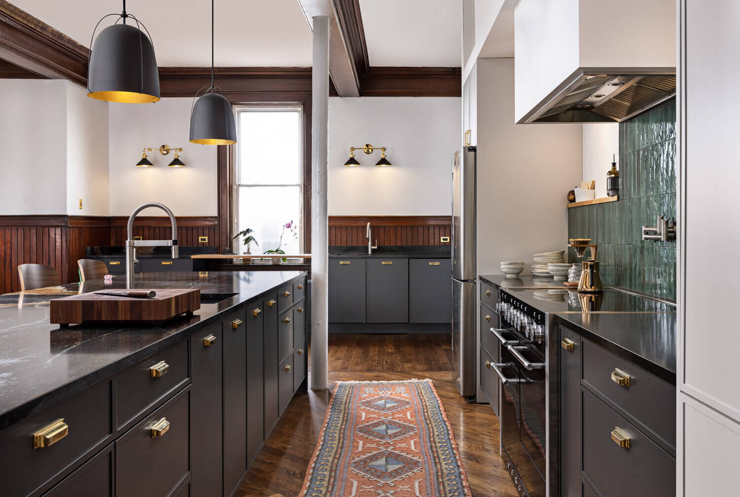 An urban remodel with charcoal gray cabinets with sleek modern shaker cabinets doors with a frameless construction.