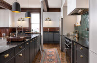 An urban remodel with charcoal gray cabinets with sleek modern shaker cabinets doors with a frameless construction.