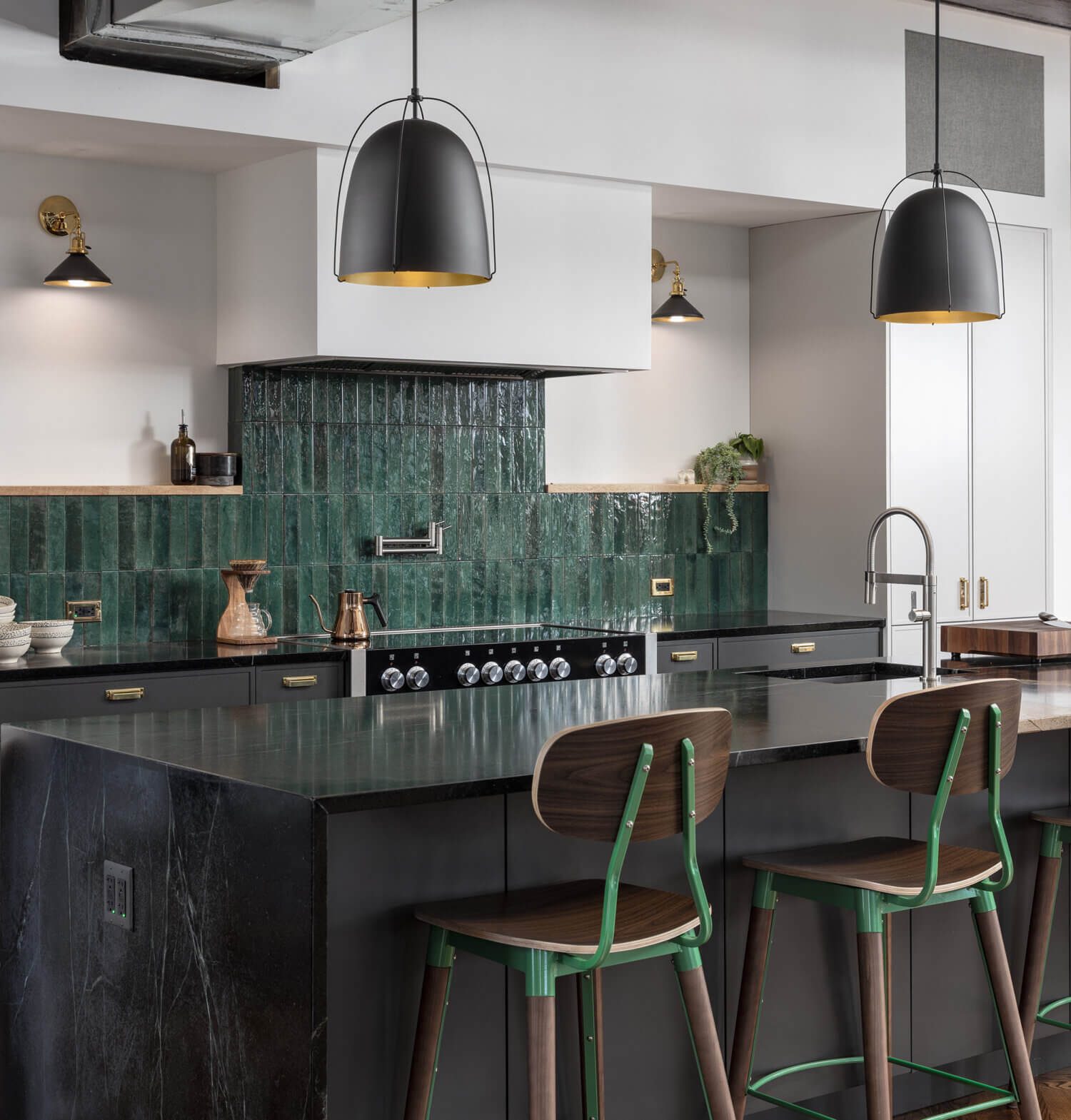 A modern kitchen with an emerald green charcoal black, and white color palette featuring a modern skinny shaker door style from Dura Supreme Cabinetry.