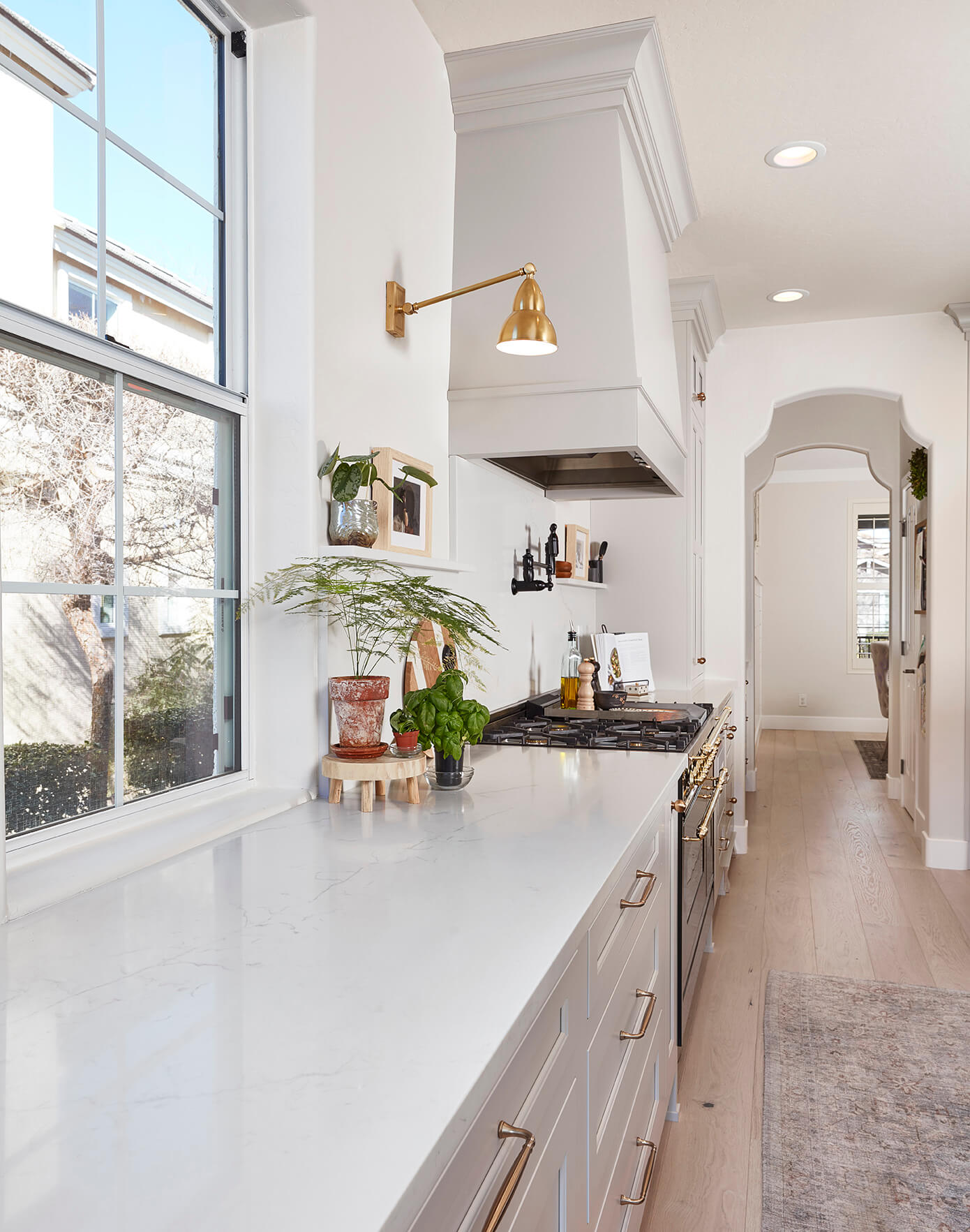 A beautiful modern farmhouse kitchen with a simplistic wood hood.