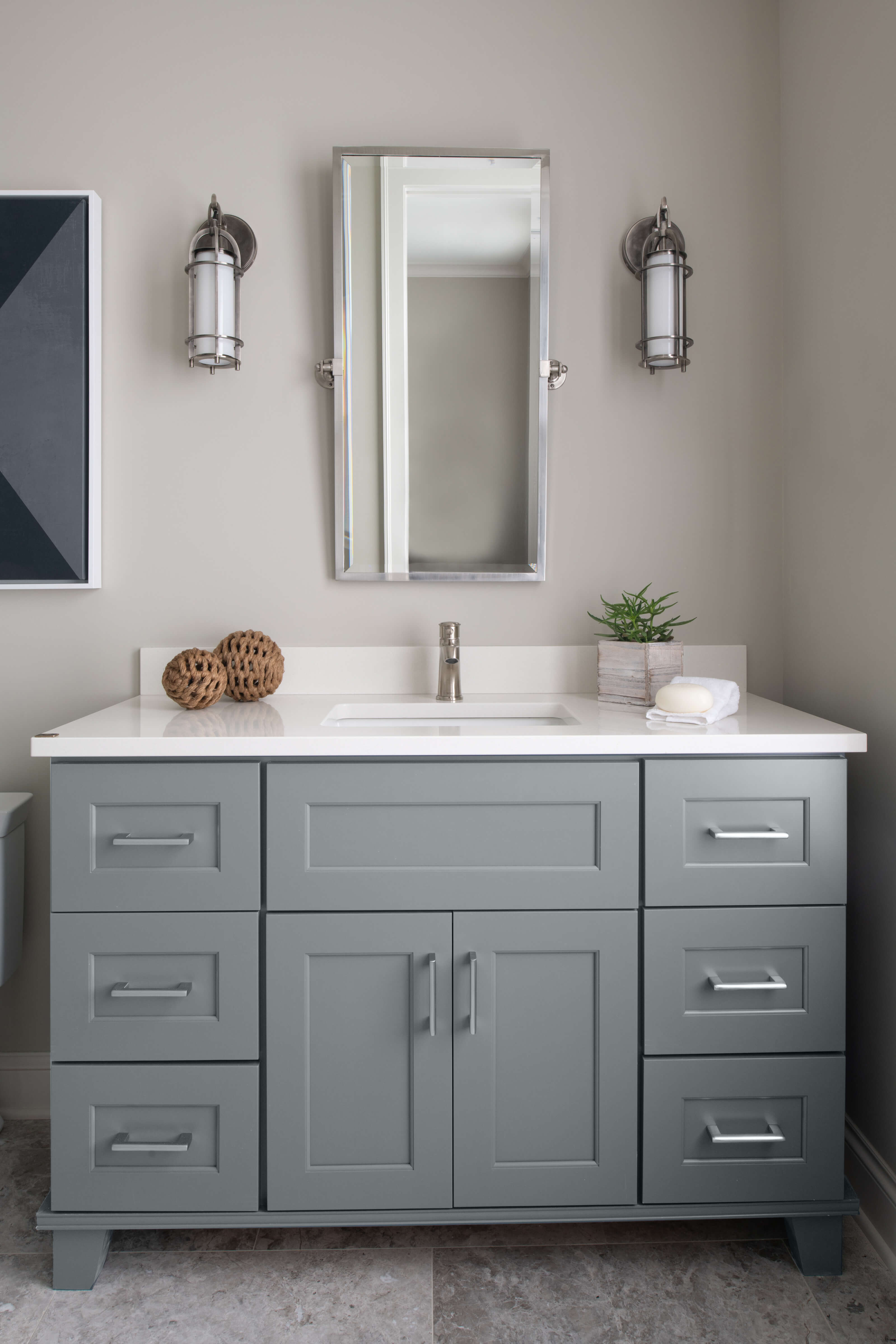 Trendy gray-blue paint color on furniture styled bathroom vanity by Dura Supreme Cabinetry. Featuring Sherwin-Williams Software paint color.
