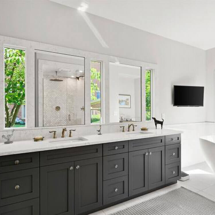 A master bathroom designed for two with a dark gray vanity with double sinks.