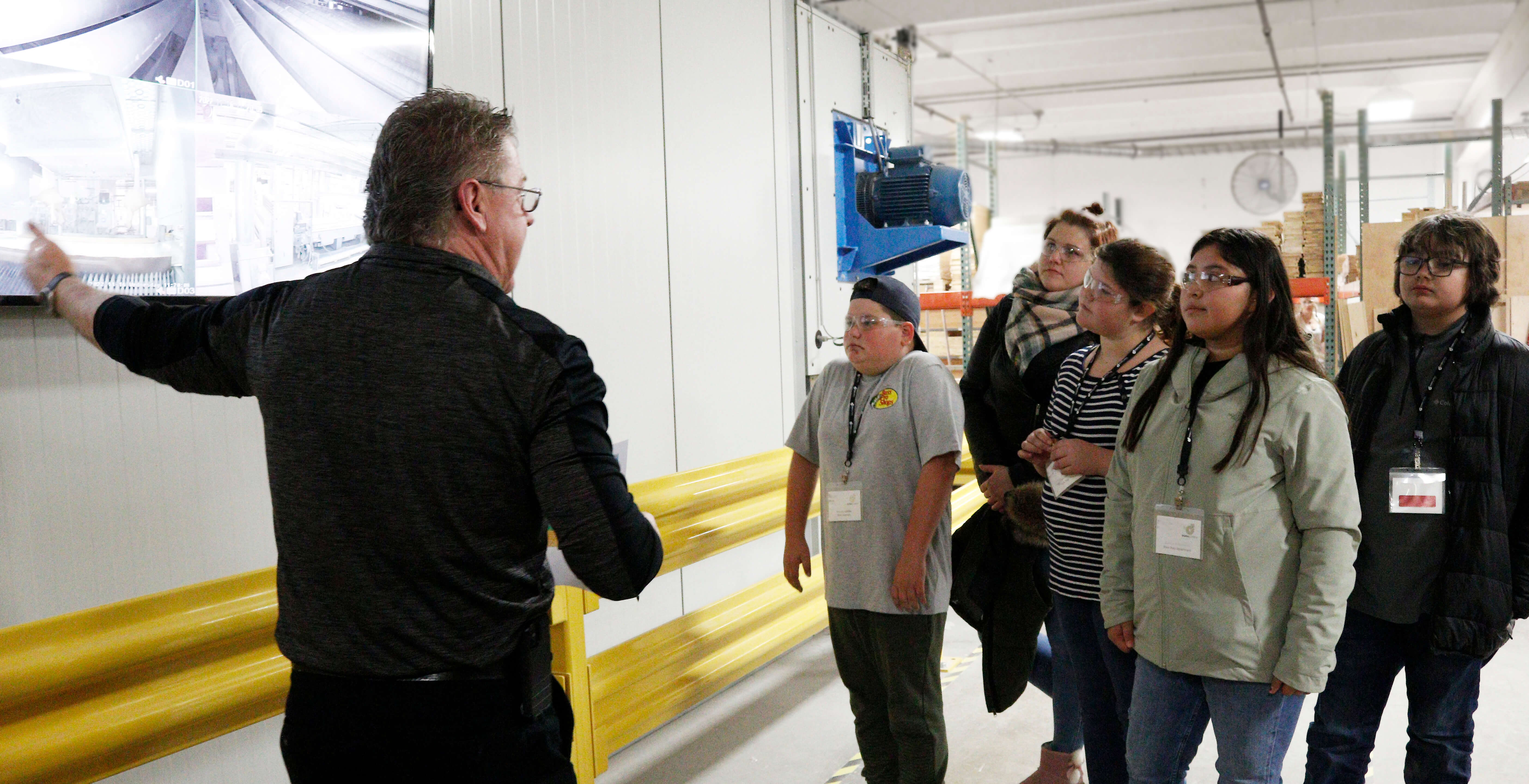 The safety manager at Dura Supreme Cabinetry giving a factory tour to a class of fifth graders.