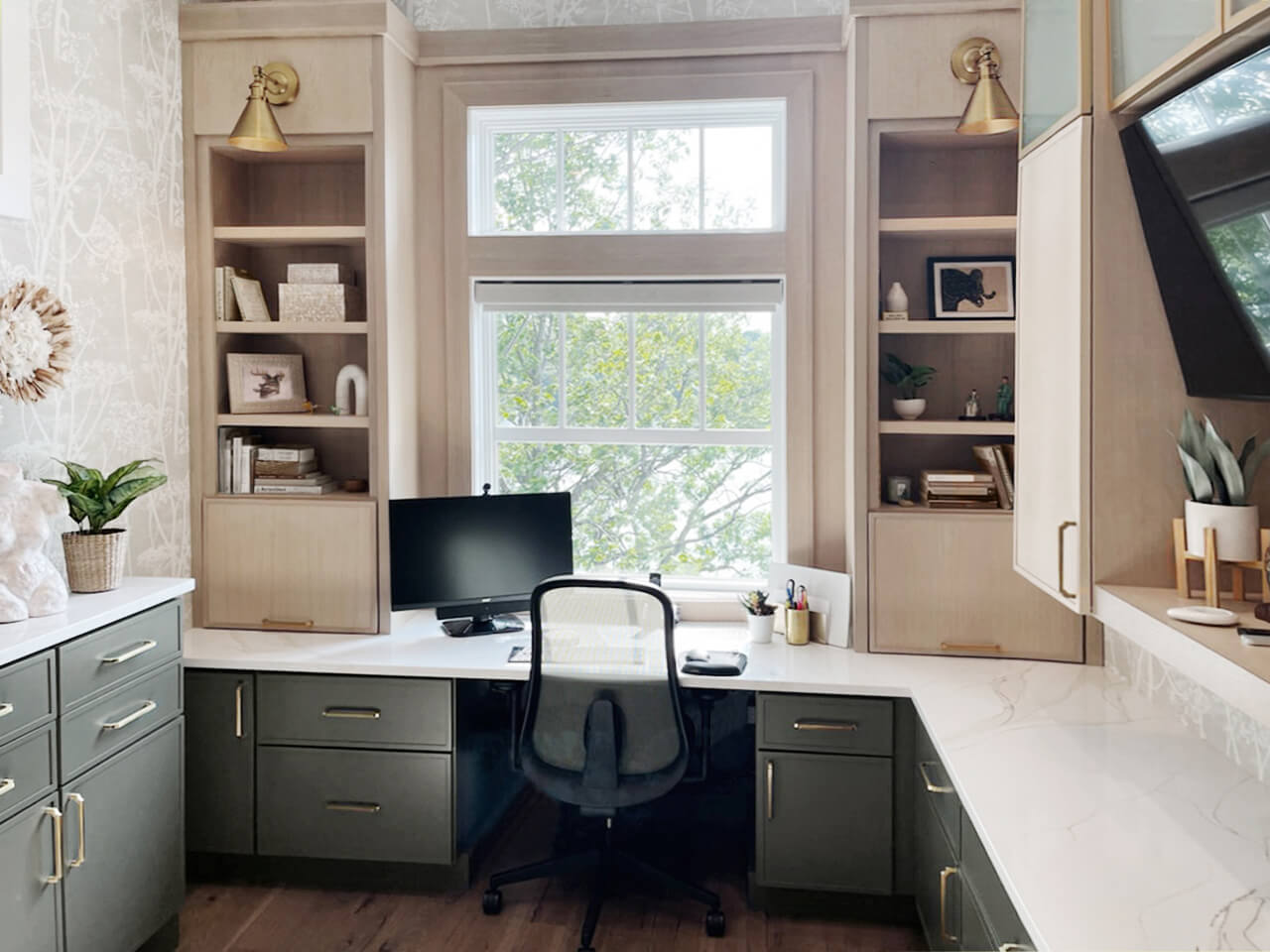 A new home office office with modern shaker doors in light wood and dark green paint colors with a window view.