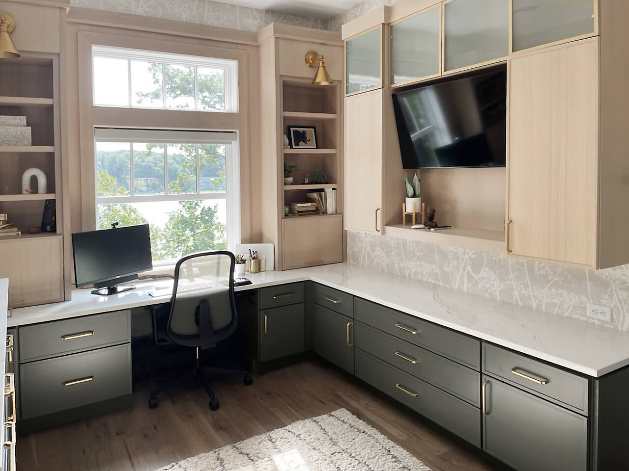 A beautiful home office with skinny shaker cabinet doors in a light, white oak and a Cast Iron paint with two towers on each side surrounding the office window.