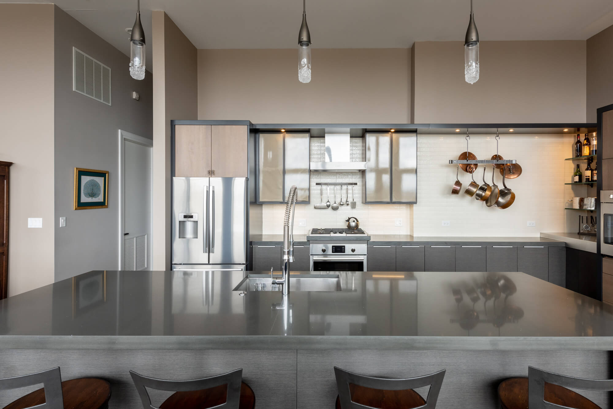 A moody urban loft style kitchen with two tone cabinets and metal cabinet accent doors.