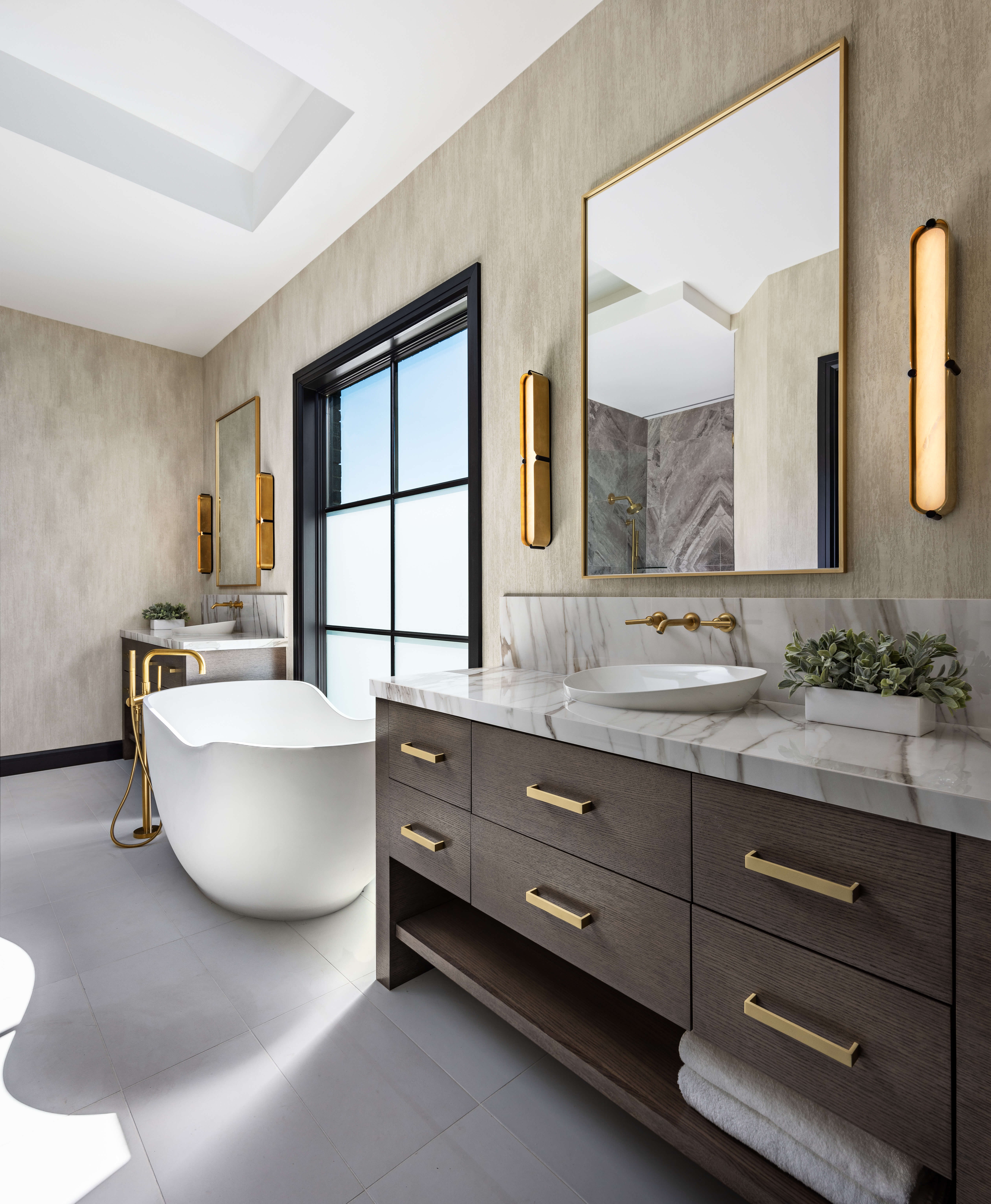 A transitional master bathroom with a dark stained furniture style vanity with modern slab cabinet doors with a horizontal wood grain and a dark stained finish.