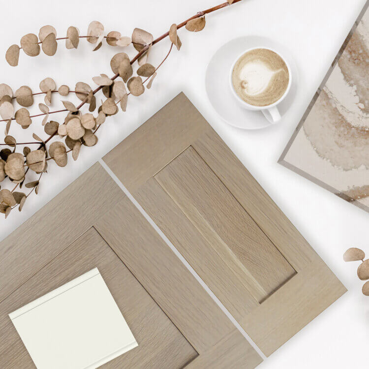 An on-trend kitchen design idea with a shallow shaker door style in a light stained Quarter-sawn White Oak wood with a sample of off-white painted finish for cabinets.