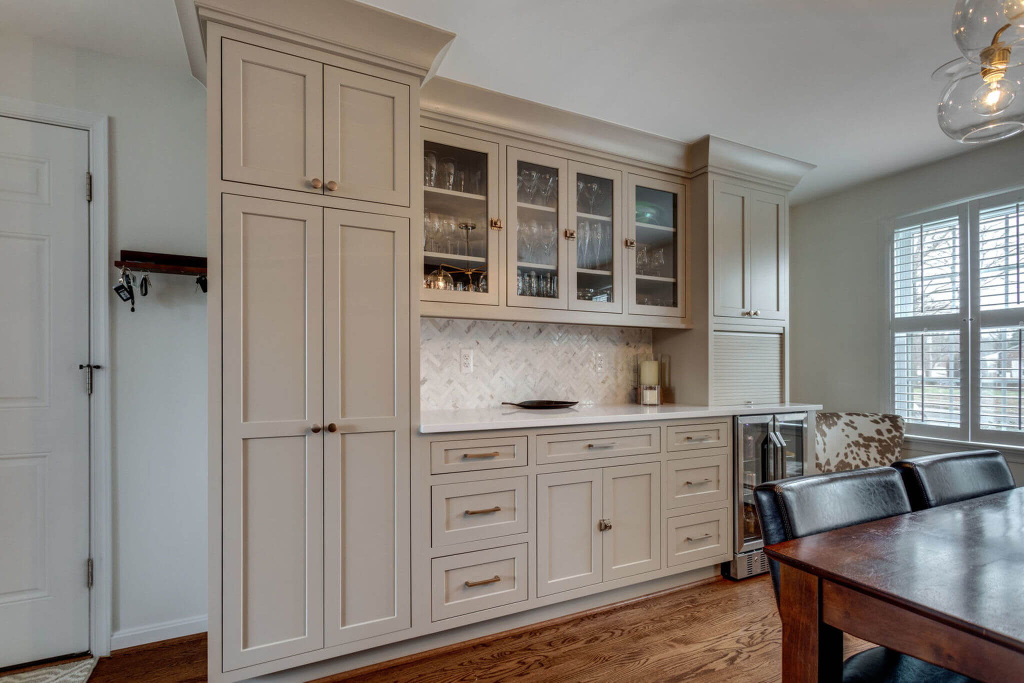 A hutch-like area of the dining room with built-in cabinetry with a beautiful painted finish in Dura Supreme's Putty paint color.