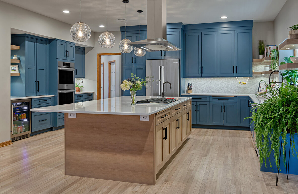 A colorful kitchen with blue painted cabinetry with a state-of-the-art factory finish on Premium HDF (High-Density Fiberboard) for a precision combination of quality painted cabinets.