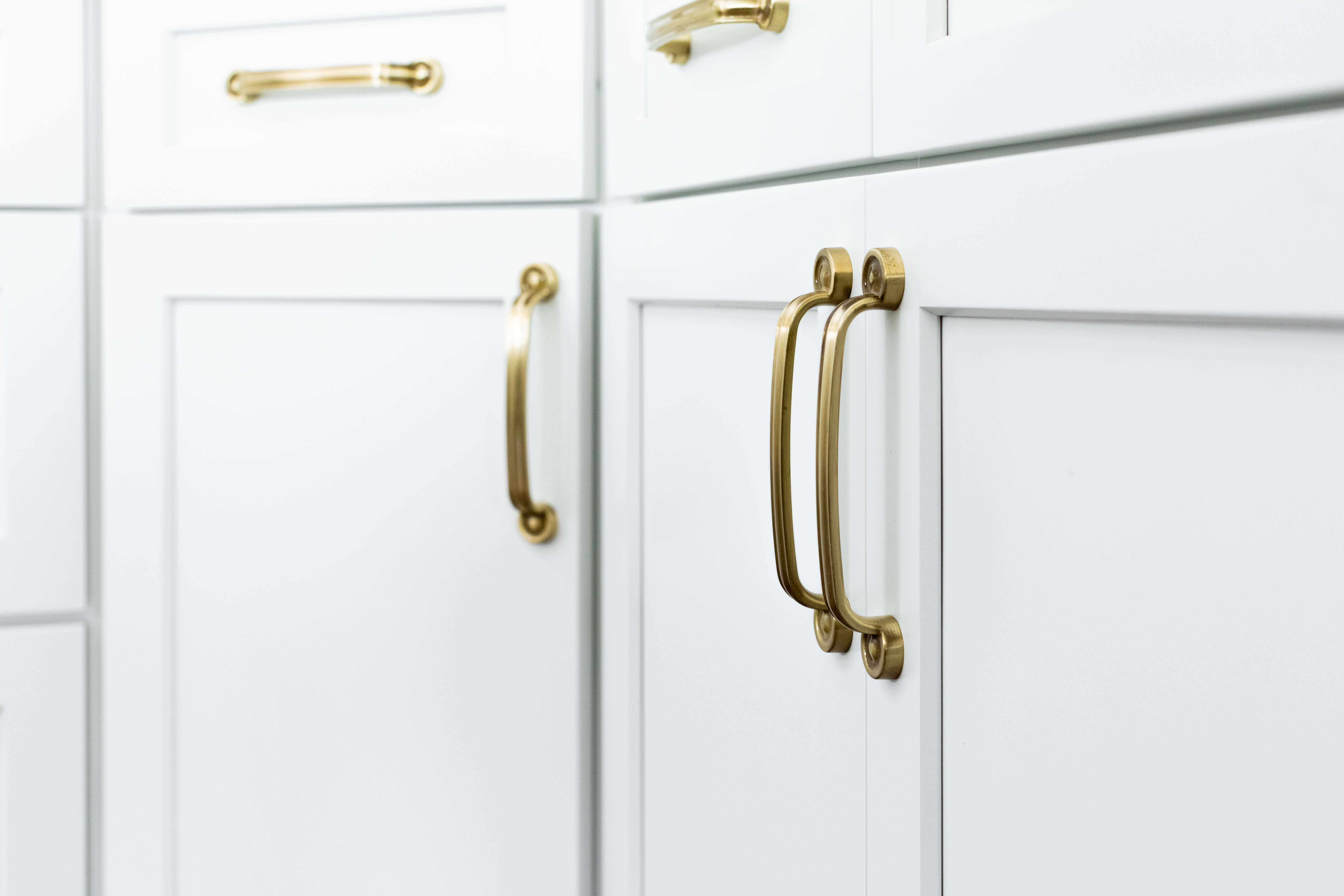 A close up of elegant white painted cabinets with a shaker door style made of Premium HDF material designed to create high-quality painted cabinetry with smooth durable surfaces, crisp details, and stable wood material.
