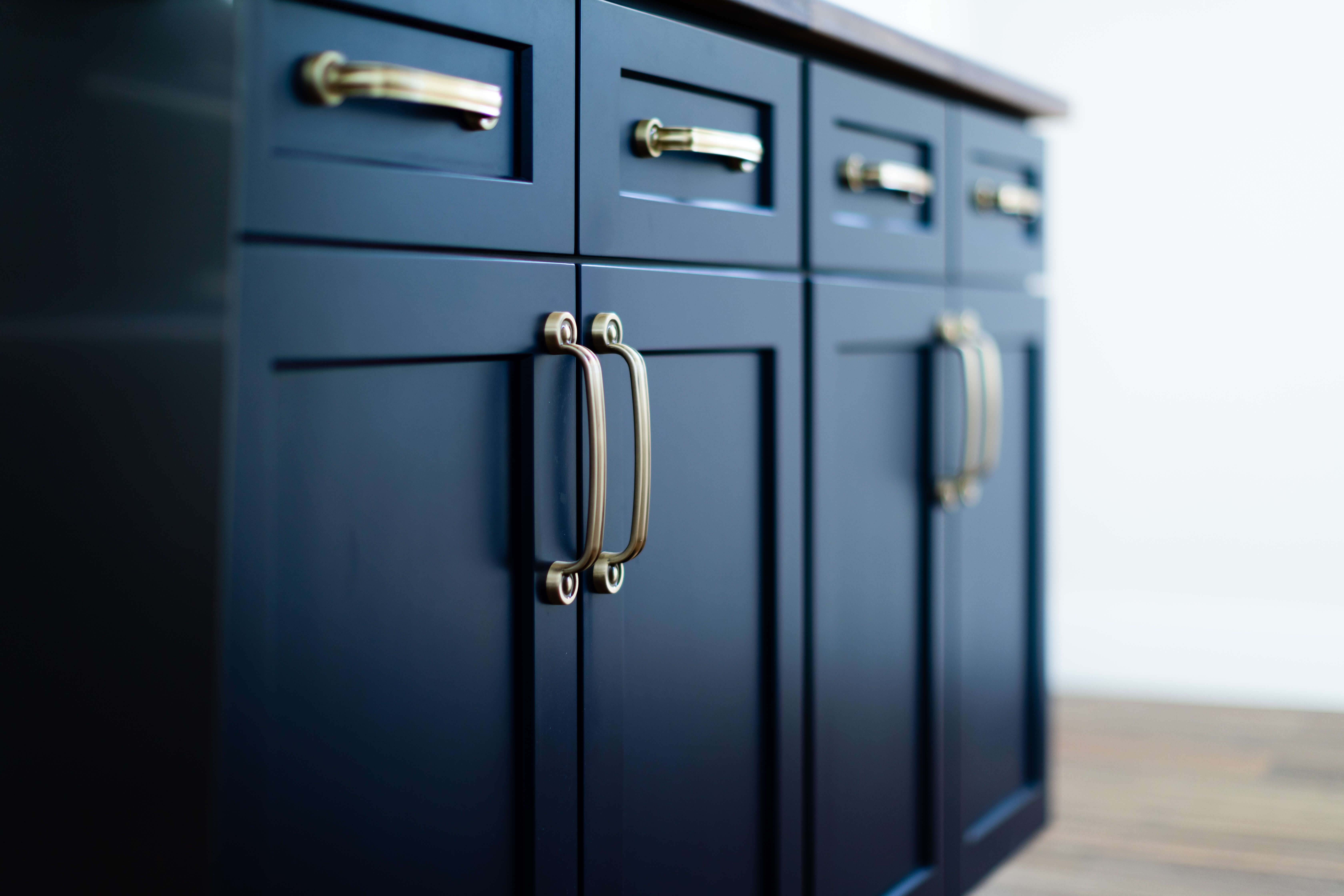 A close up of dark navy blue painted kitchen cabinets with an Ultra-dense and hard Premium HDF (High-Density Fiberboard) construction and a 15-step factory finish.