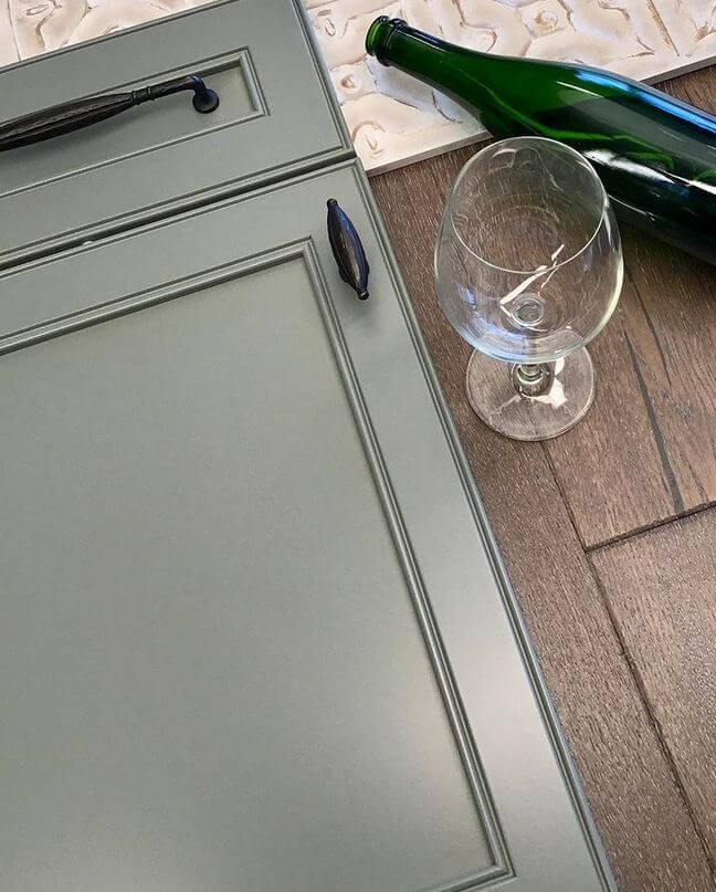 A green painted cabinet door with a smooth, crisp painted surface using Dura Supreme's Paintable wood species with HDF.