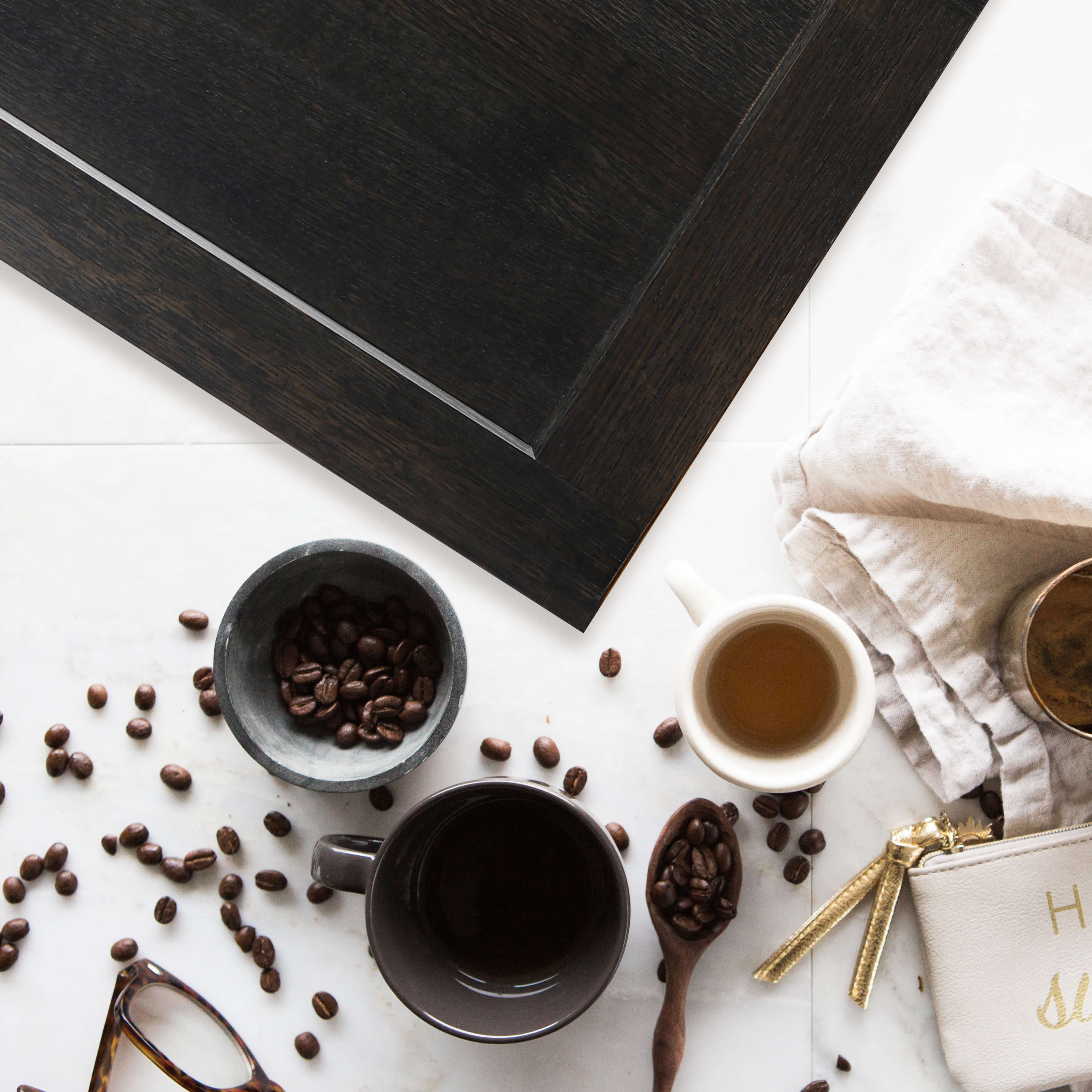 A dark, almost black, Onyx stained Quarter-Sawn White Oak shaker door laying on a white countertop.