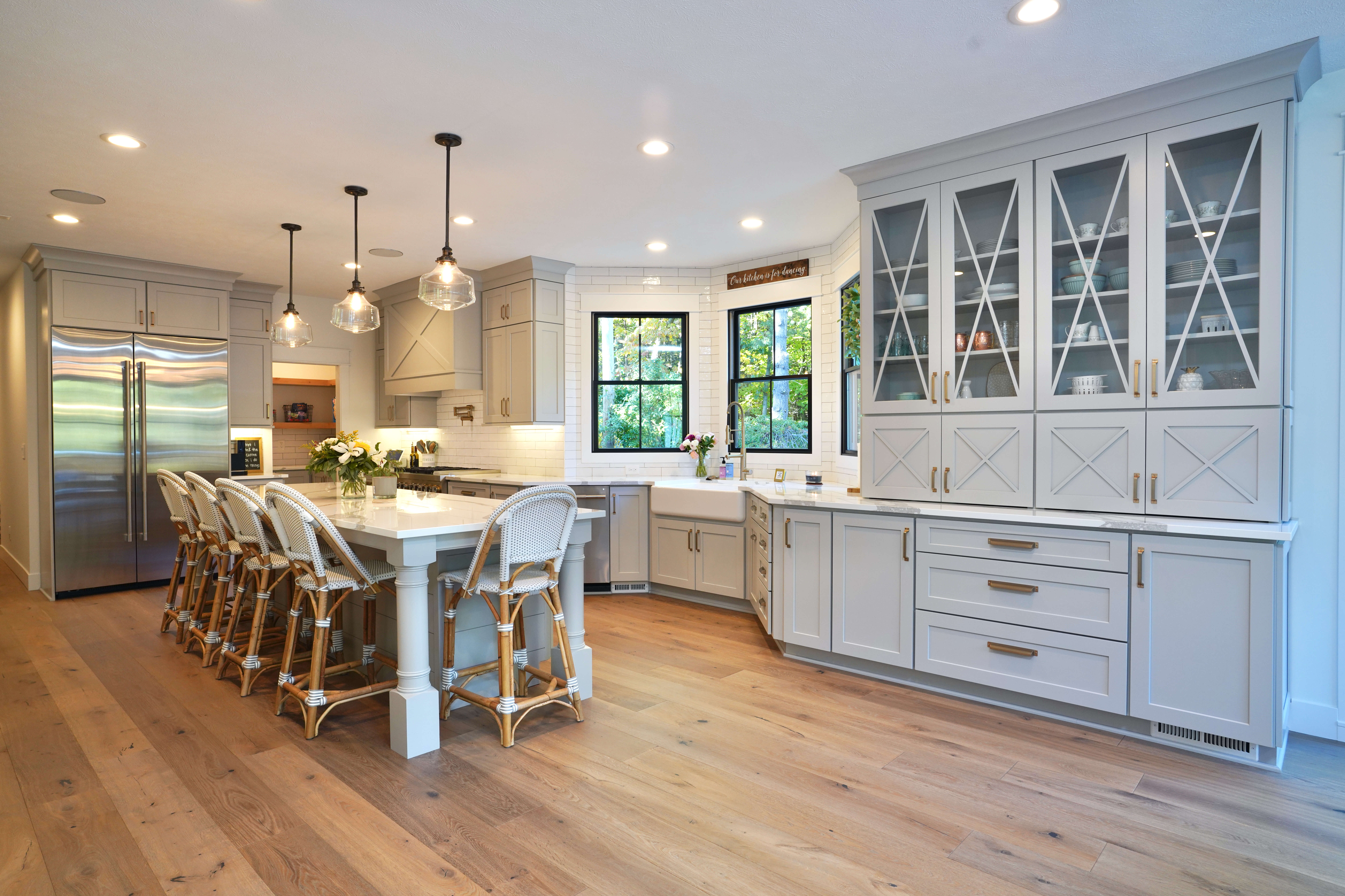 A beautiful kitchen with quality painted cabinetry from Dura Supreme Cabinetry in a light gray painted finish.