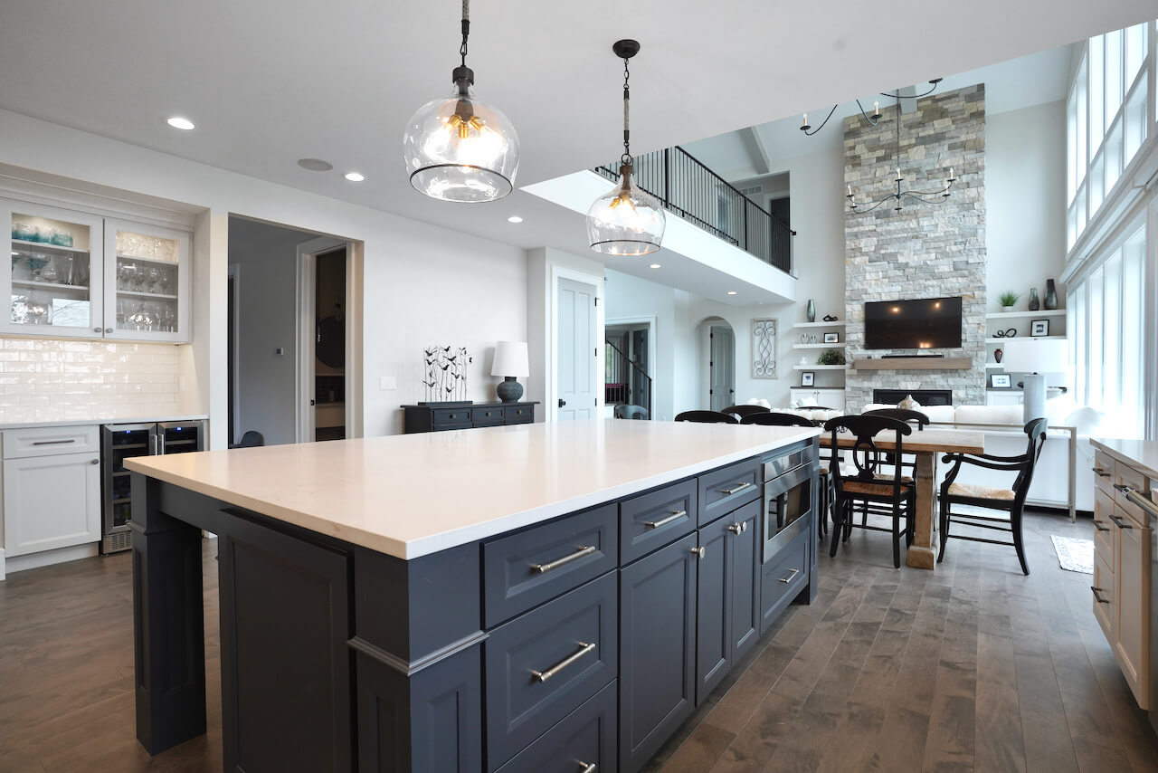 A trendy dark navy blue painted kitchen island in an open concept kitchen remodel with the best wood material for painted wood cabinets., Premium HDF.