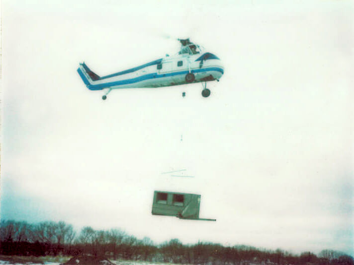The helicopter lifting the Air Make unit to the roof of the Dura Supreme manufacturing facility when it was built in 1980.