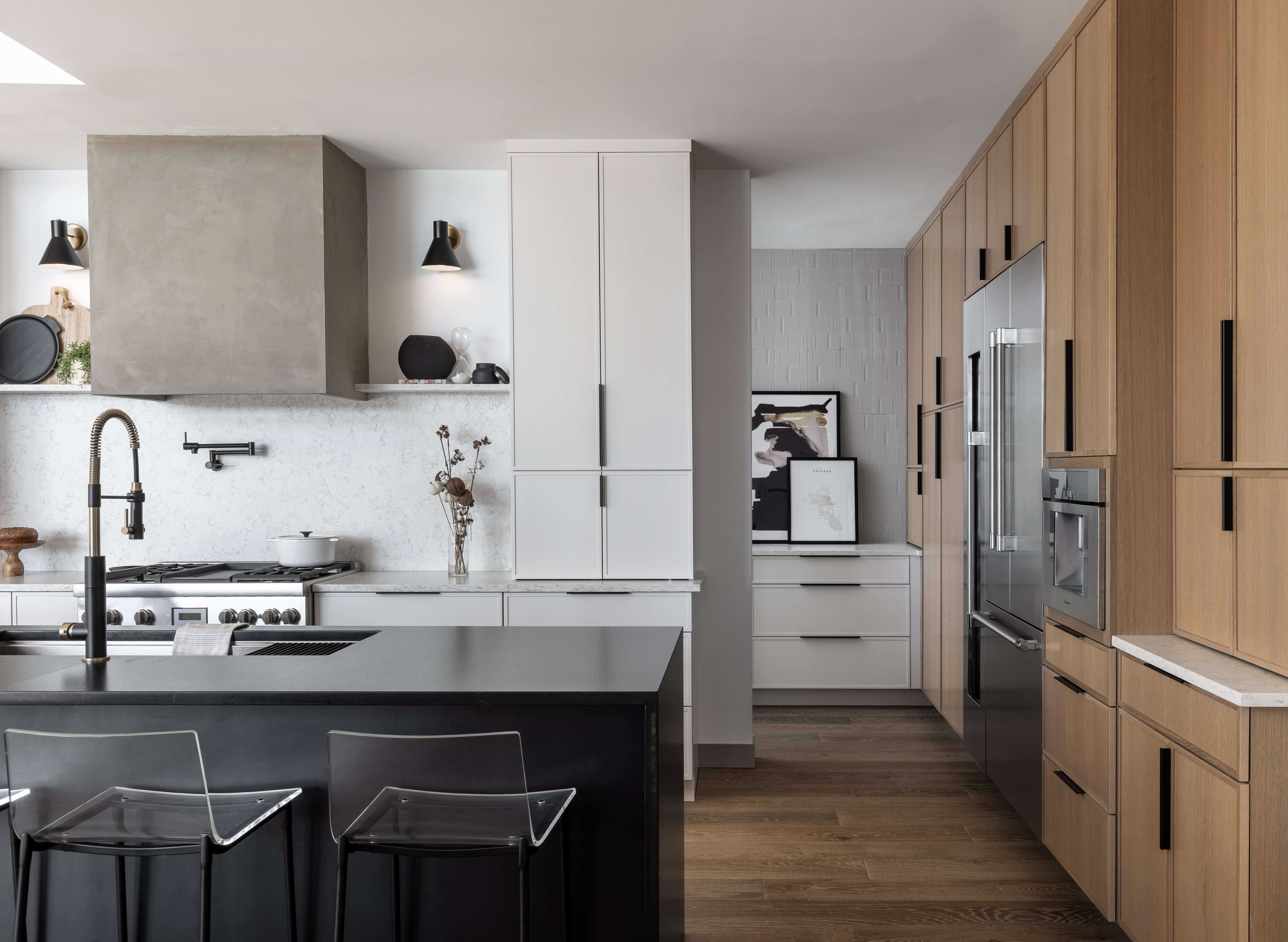 Less is more in this luxurious and simplistic kitchen remodel with skinny shaker doors and a modern hood.