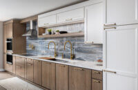 A two-toned one-wall kitchen with white and medium stained cabinets from Dura Supreme.