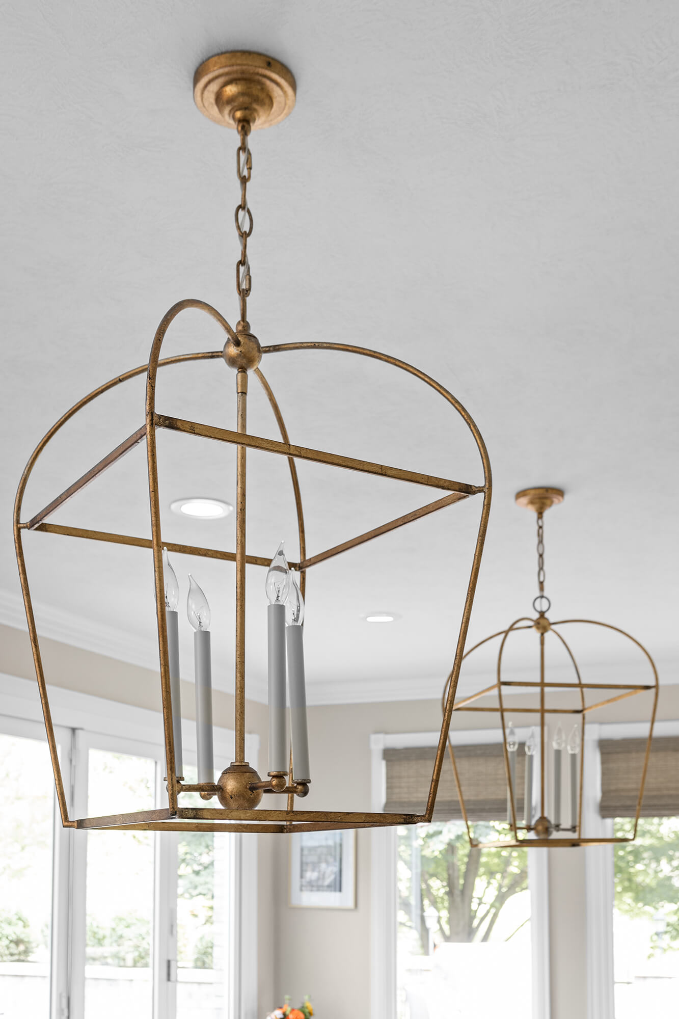 The light fixtures use a brushed brass to accent other colors in the kitchen design.