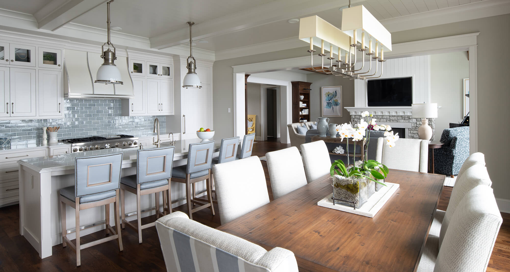 A beautiful coastal kitchen design with white cabinets, light blue decor, and rich true-brown stains.