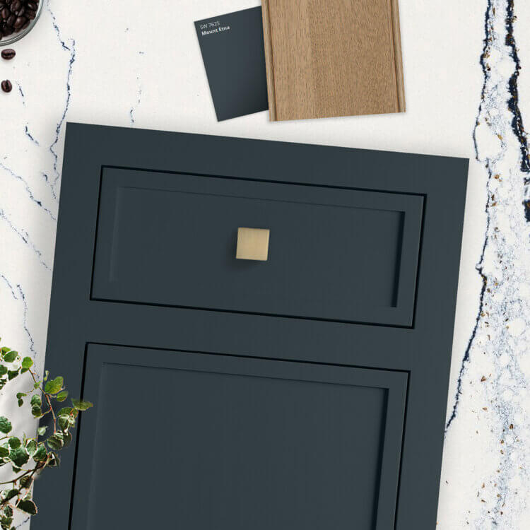 A trending kitchen color design concept in a flat mood board showing a green cabinet door and a light stained wood with a dramatic quartz countertop.