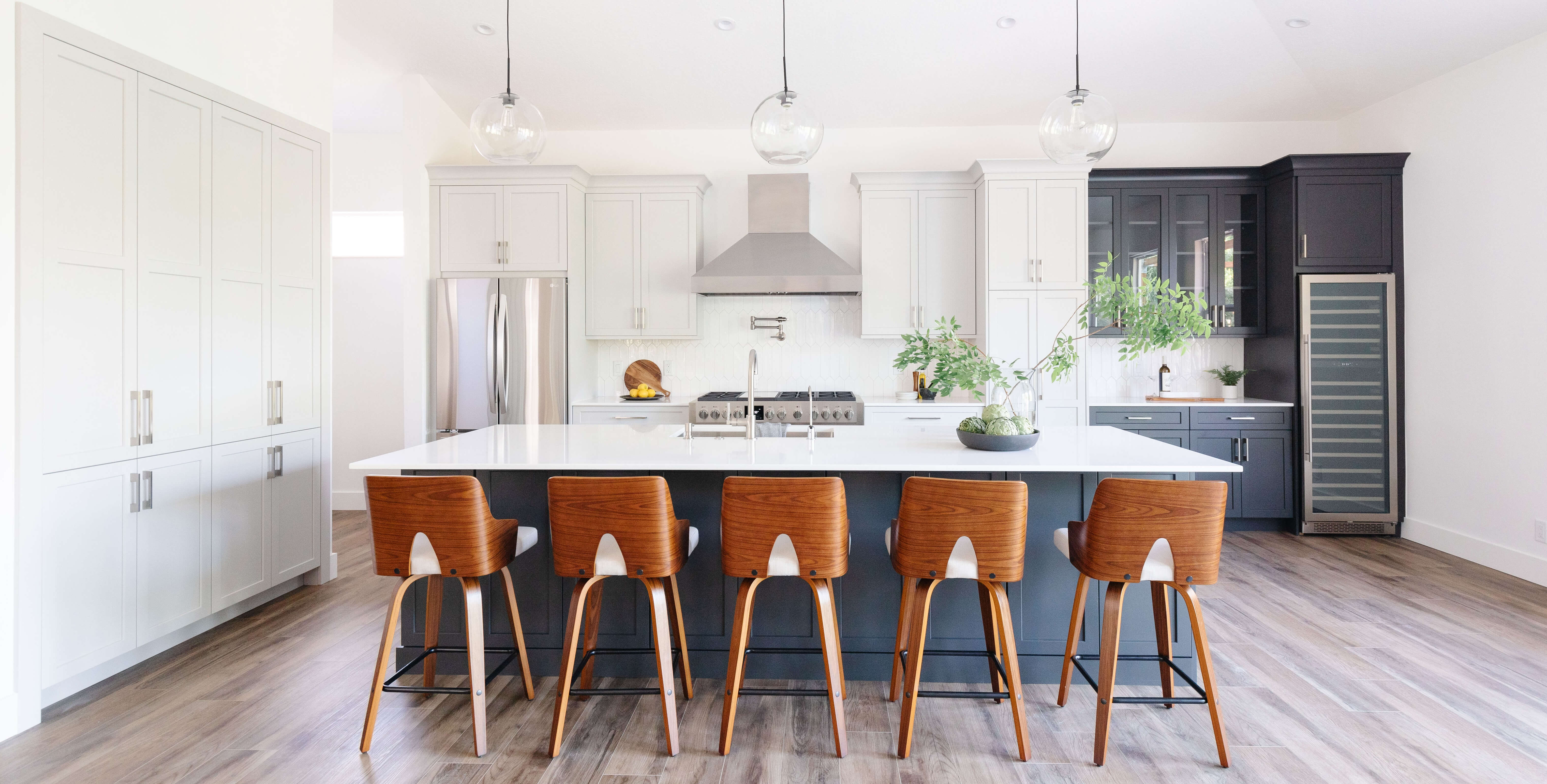 A black and white midcentury modern styled kitchen design with shaker style cabinets.