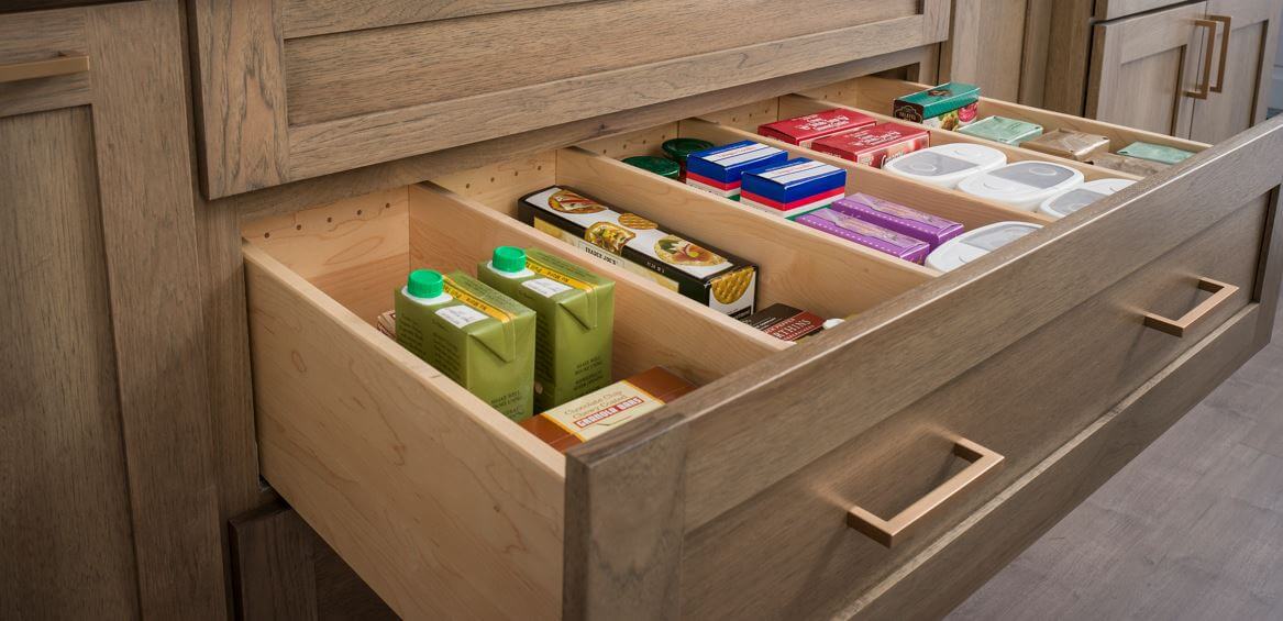 A deep drawer with partitions that could be used in a closet for sorting clothing.