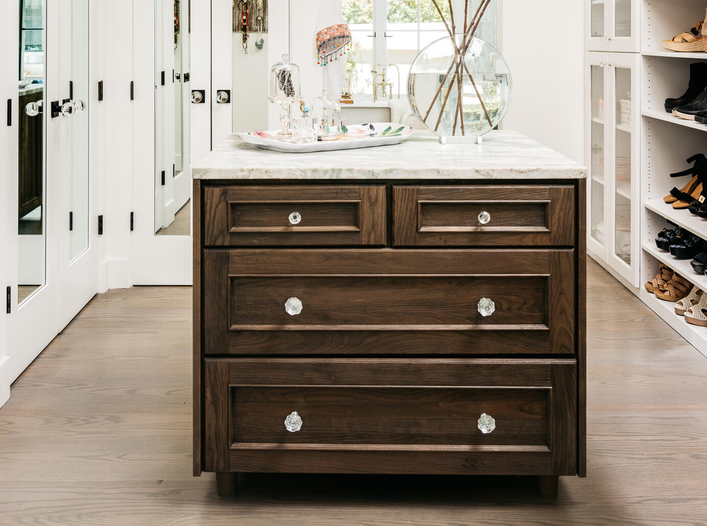 A kitchen island used in a master bedroom wlak-in closet for storage and a workspace.