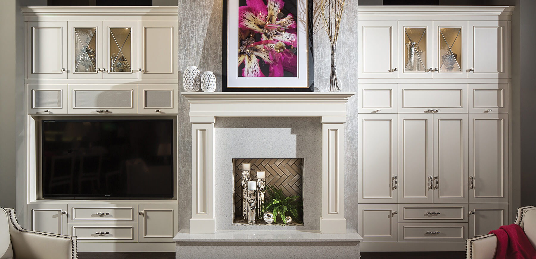 A full wall of entertainment center cabinets built in around the fireplace.