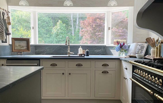 A beautiful inset kitchen with natural off-white painted cabinets from Dura Supreme.