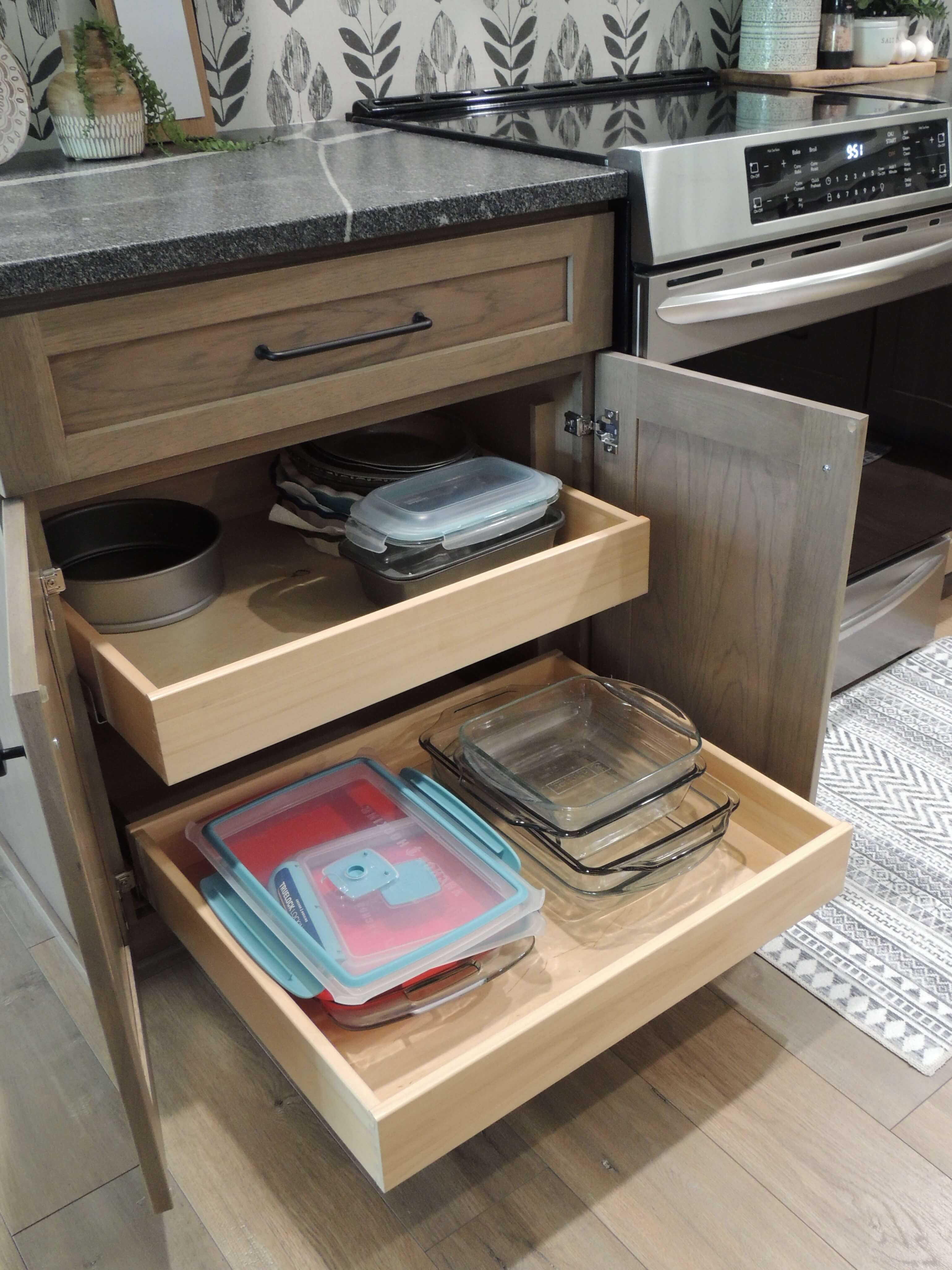 A stained hickory cabinet opens up to reveal 2 roll-out shelves for easy access storage.