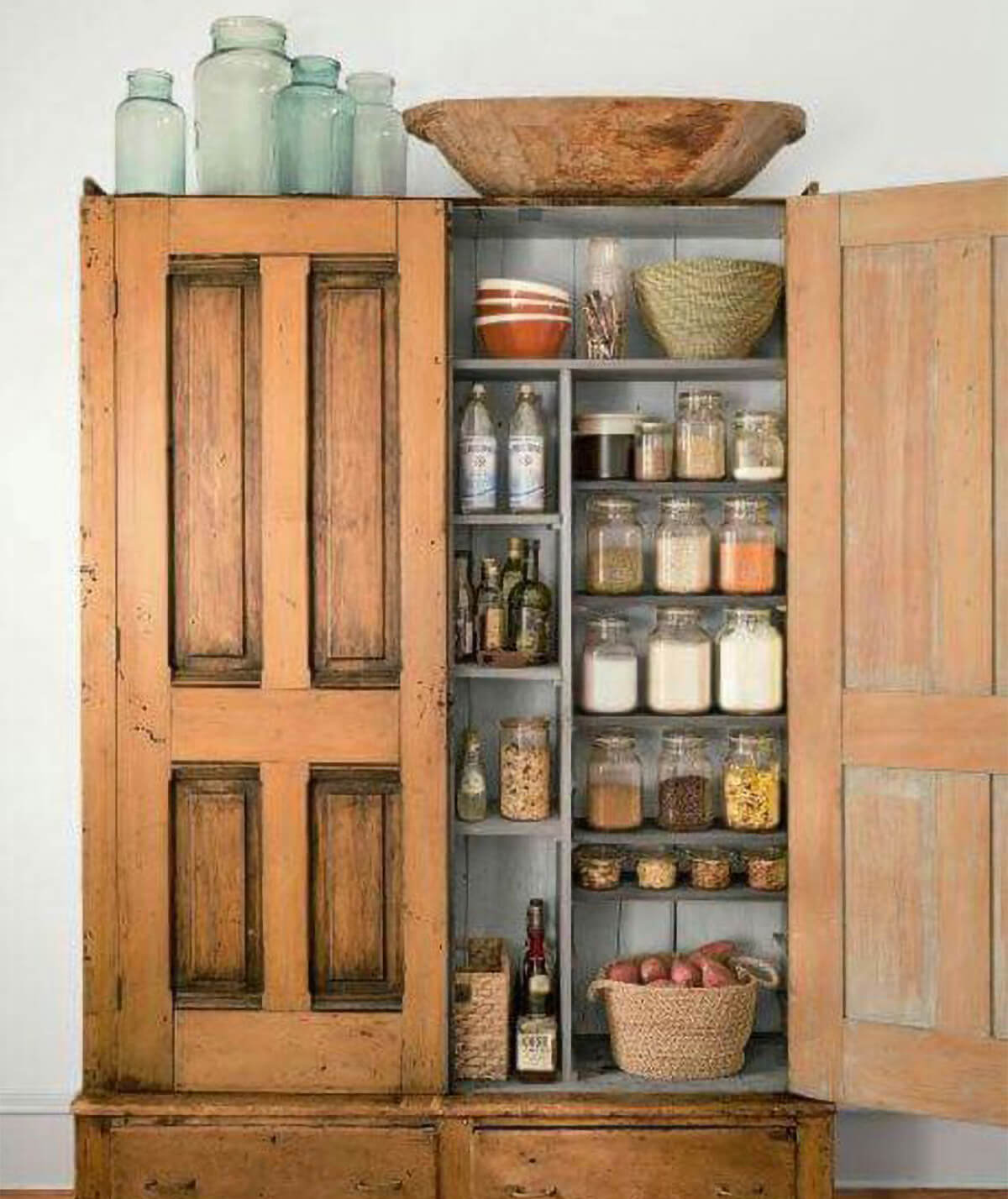 An antique larder cabinet that was refurbished into a pantry.