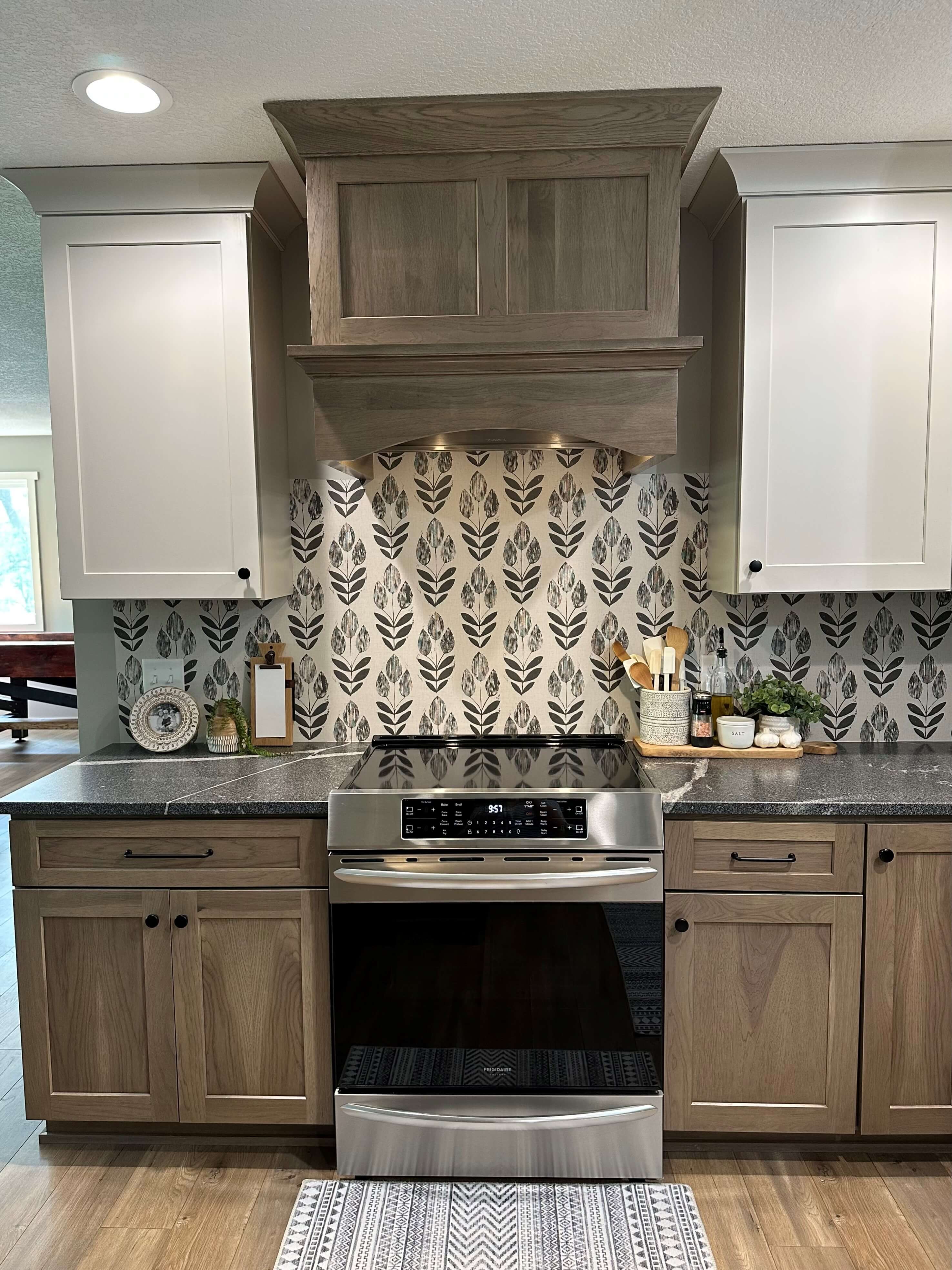 A two-toned kitchen design with hickory cabinets and off-white painted cabinets for the wall cabinets.