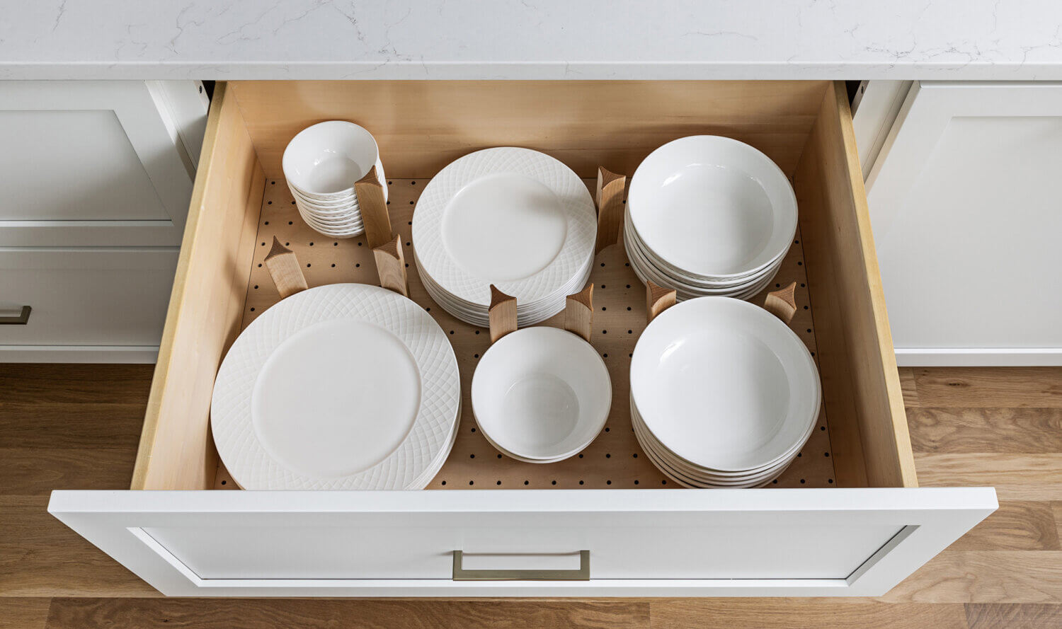 A deep drawer with a dish rack drawer for plates and bowls.