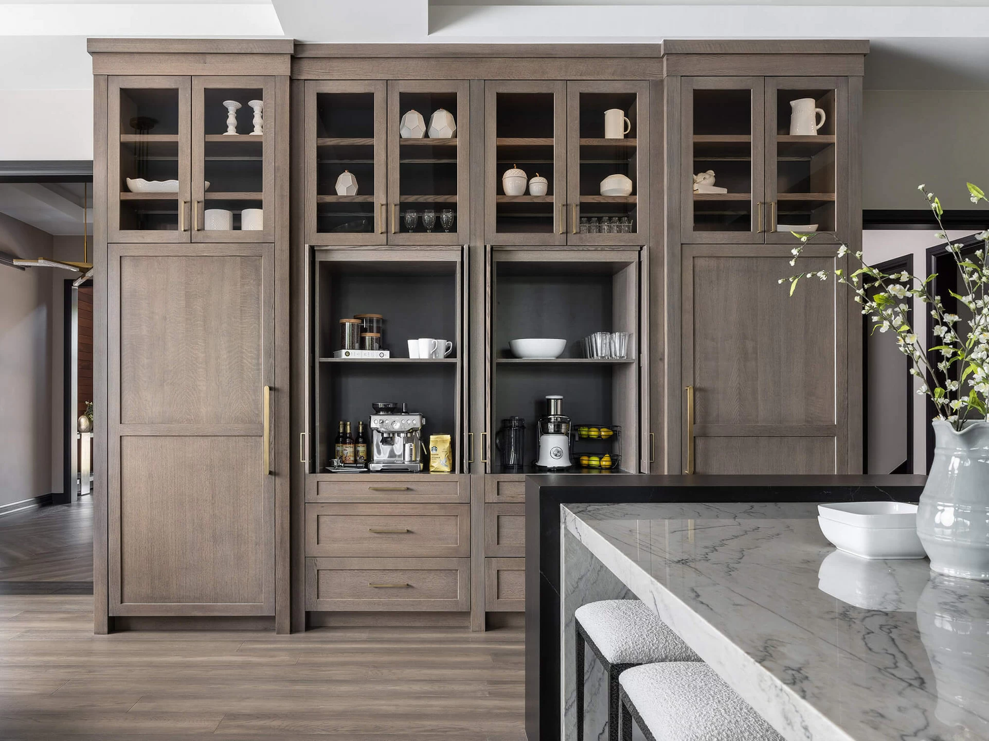 The cabinets open to reveal 2 Beautiful, hidden workstations using larder cabinets. One cabinet is used as a coffee station and the other as a smoothie station.