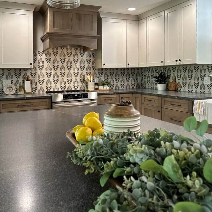 A two tone kitchen remodel with a wood hood and cabinets from Dura Supreme.