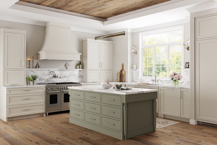 This quality kitchen features framed cabinets from Dura Supreme's Crestwood product line. Featuring natural off-white painted flat panel cabinets and slab inset cabinets with a light sage green paint color for the island.