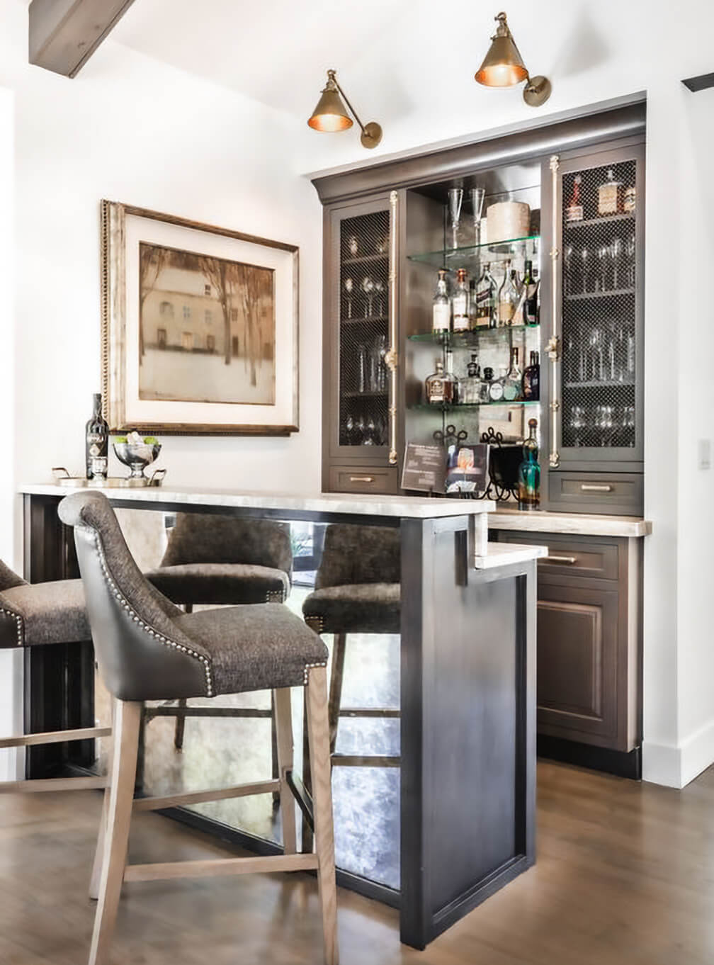 A beautiful home bar and wet bar space with wire mesh inserts on the display cabinets instead of traditional glass.